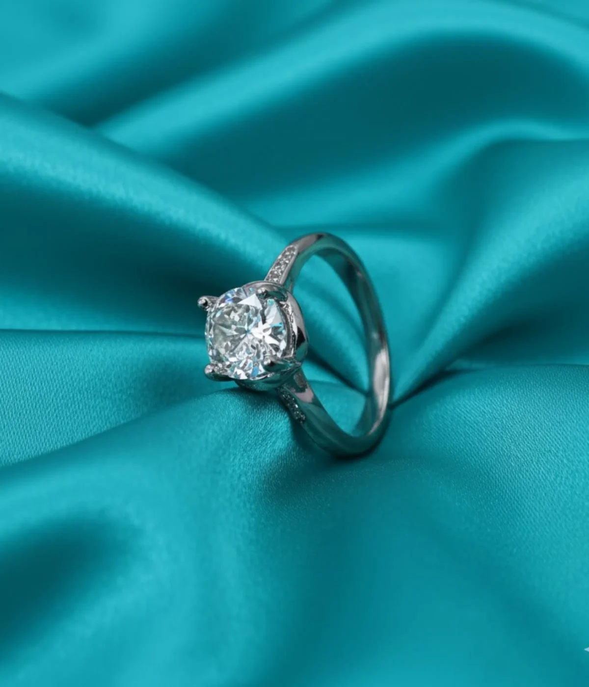 Sterling Silver Solitaire Ring. Classic design with a brilliant Round CZ center stone and Pave accent stones on the band. Ideal Engagement or Promise Ring.