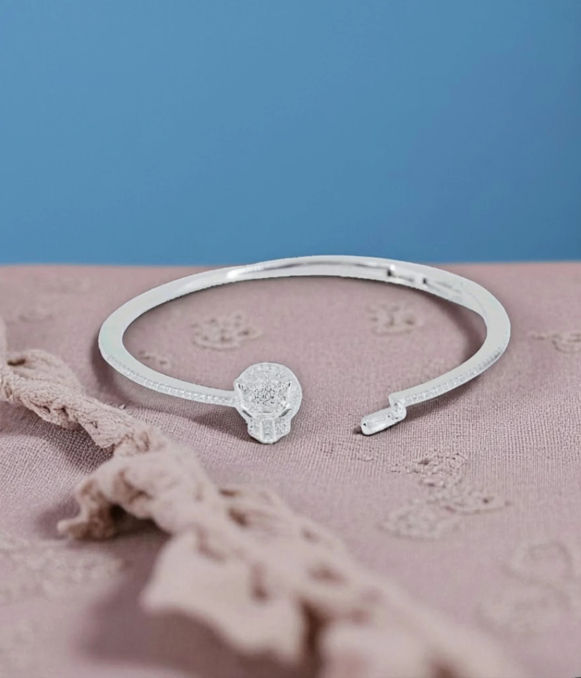 Neersterling Silver-tone open cuff bangle with a pave CZ circle centerpiece and rhinestone-lined edges.