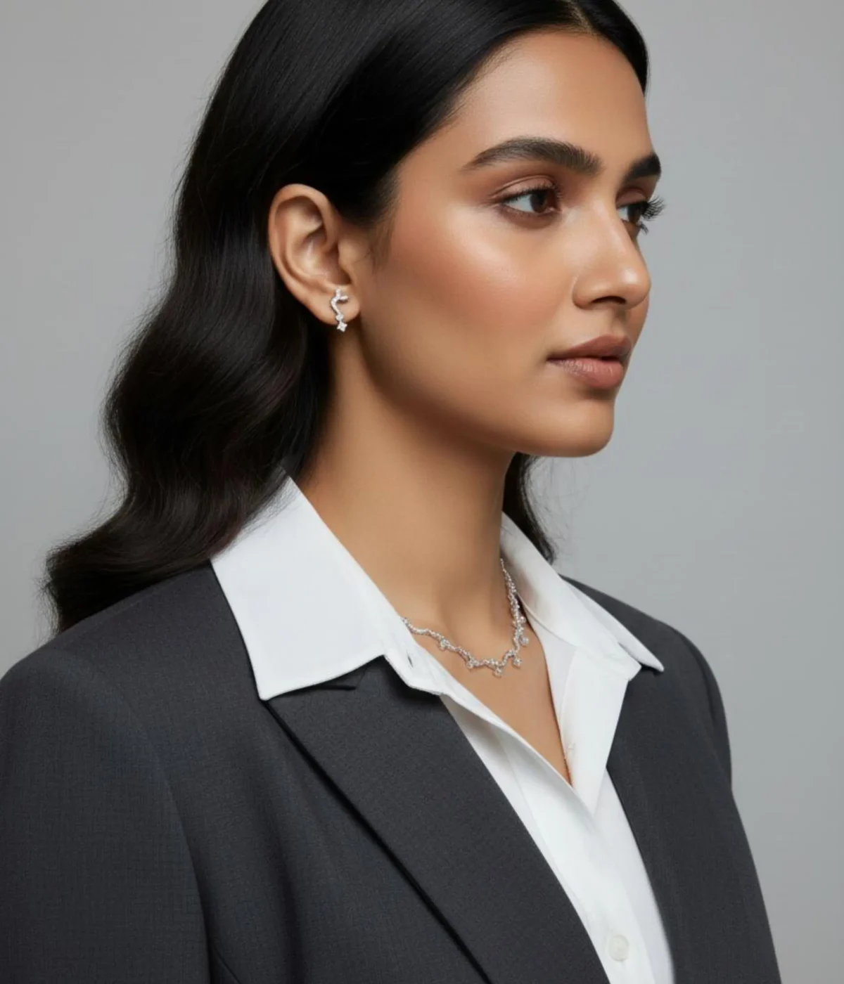 Elegant Zircon Wave Necklace and Earring Set. The necklace features a curved, sparkling diamond-style design, paired with climber stud earrings.