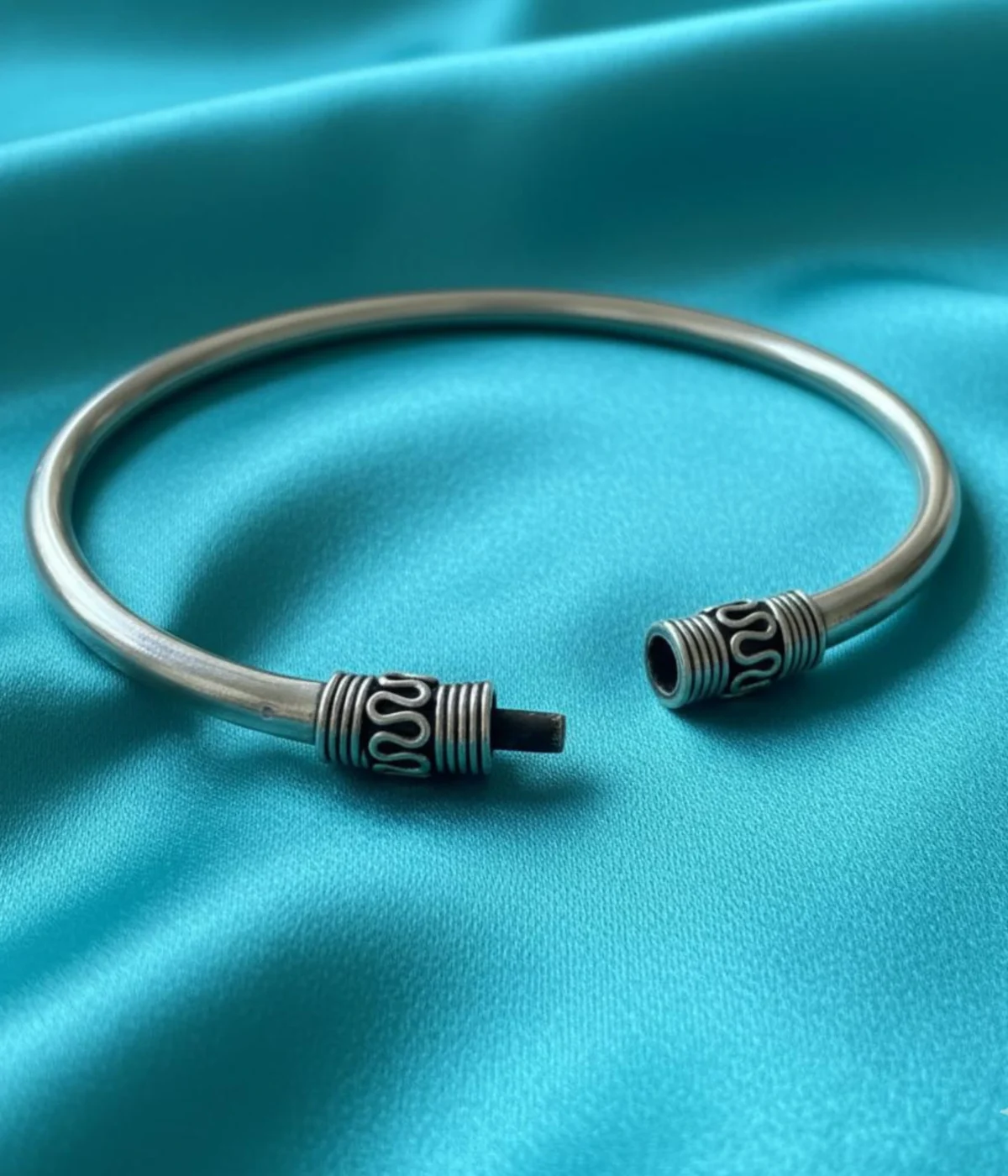Solid Sterling Silver Lock Bangle with a smooth band. Features decorative, oxidized wirework cylinders at the pin closure. Traditional Tribal Kada for daily wear.