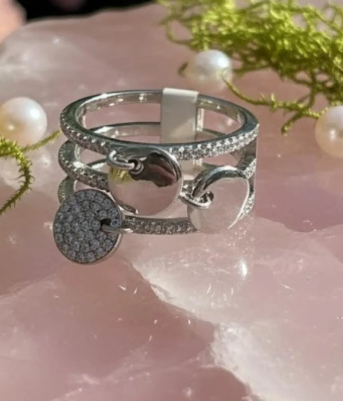 Sterling Silver Multi-Band Ring Set. Features a layered look of pave CZ and polished bands with dangling disc charms. Trendy stackable fashion ring.