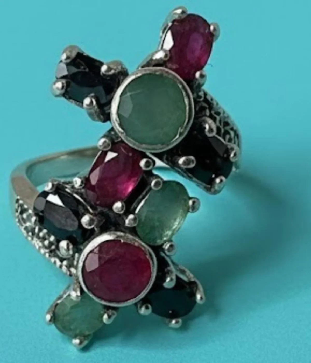 Oxidized Sterling Silver Multi-Gemstone Statement Ring. Features a Tri-Color cluster of Ruby, Emerald, and Black Onyx stones in a vintage-style criss-cross design. Cocktail Ring jewelry.