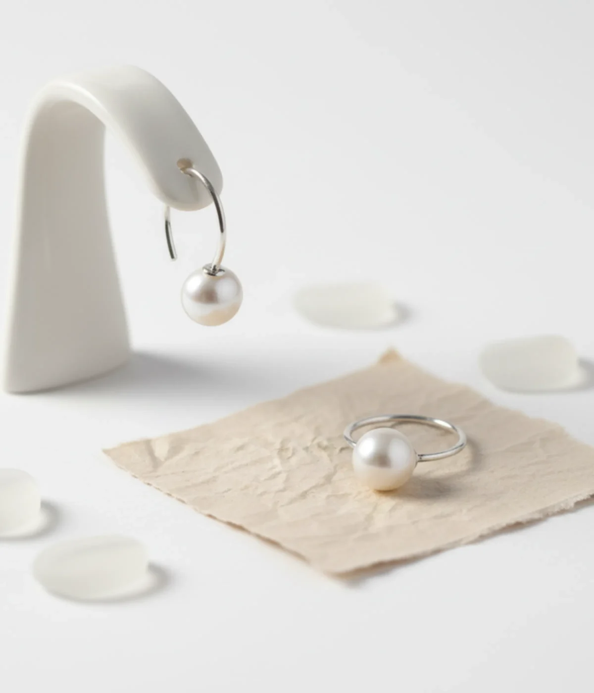 Sterling Silver Real Pearl Drop Hoop Earring. A dainty minimalist design featuring a single round Freshwater Pearl suspended from a simple silver hook/hoop.