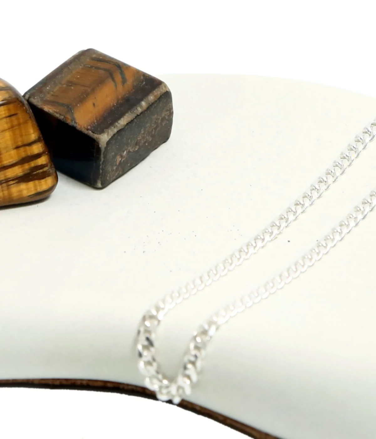 Men's Sterling Silver Curb Chain Bracelet (Cuban link style) displayed on a dark surface next to polished Tiger's Eye stones. A classic 925 Silver Link Kada.