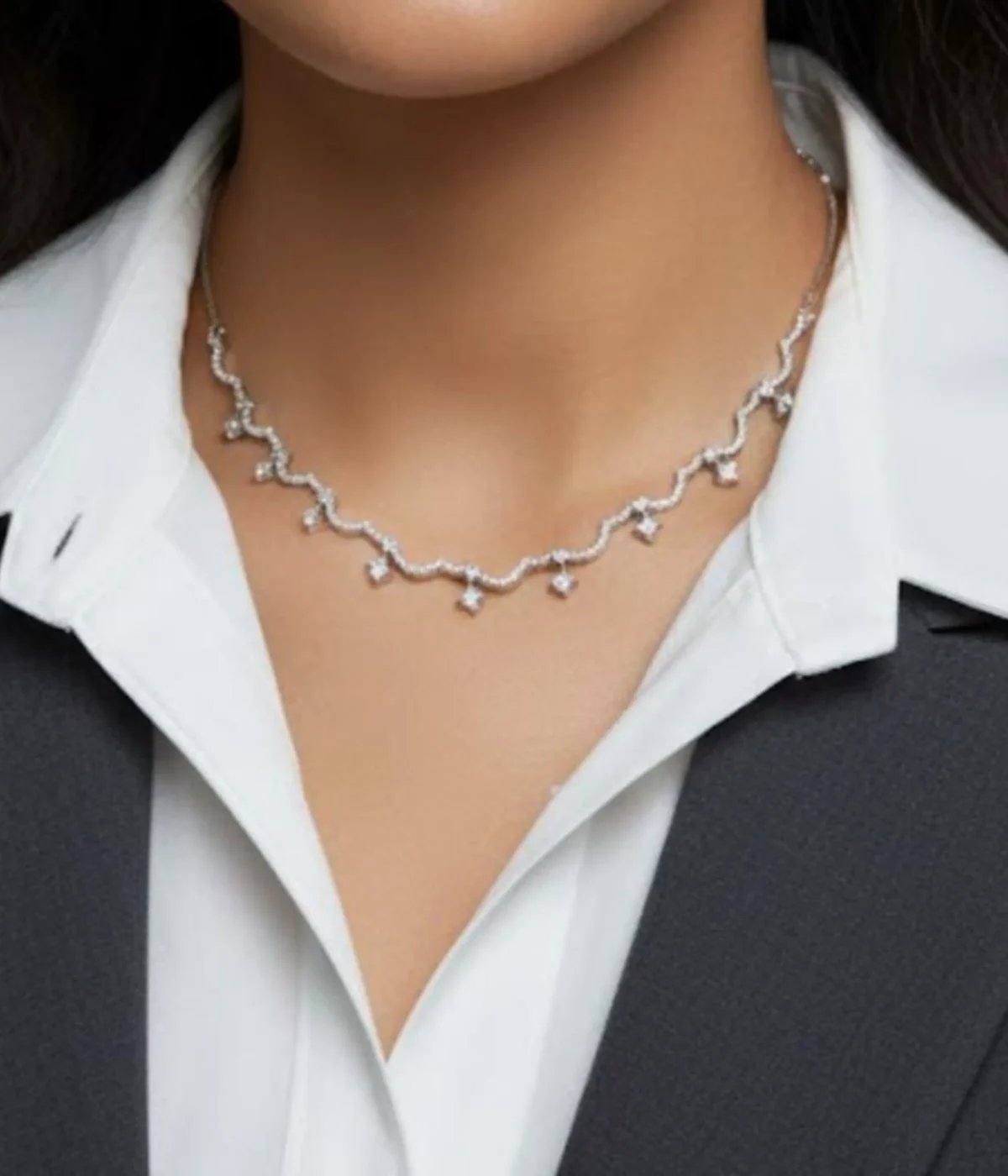 Elegant Zircon Wave Necklace and Earring Set. The necklace features a curved, sparkling diamond-style design, paired with climber stud earrings.