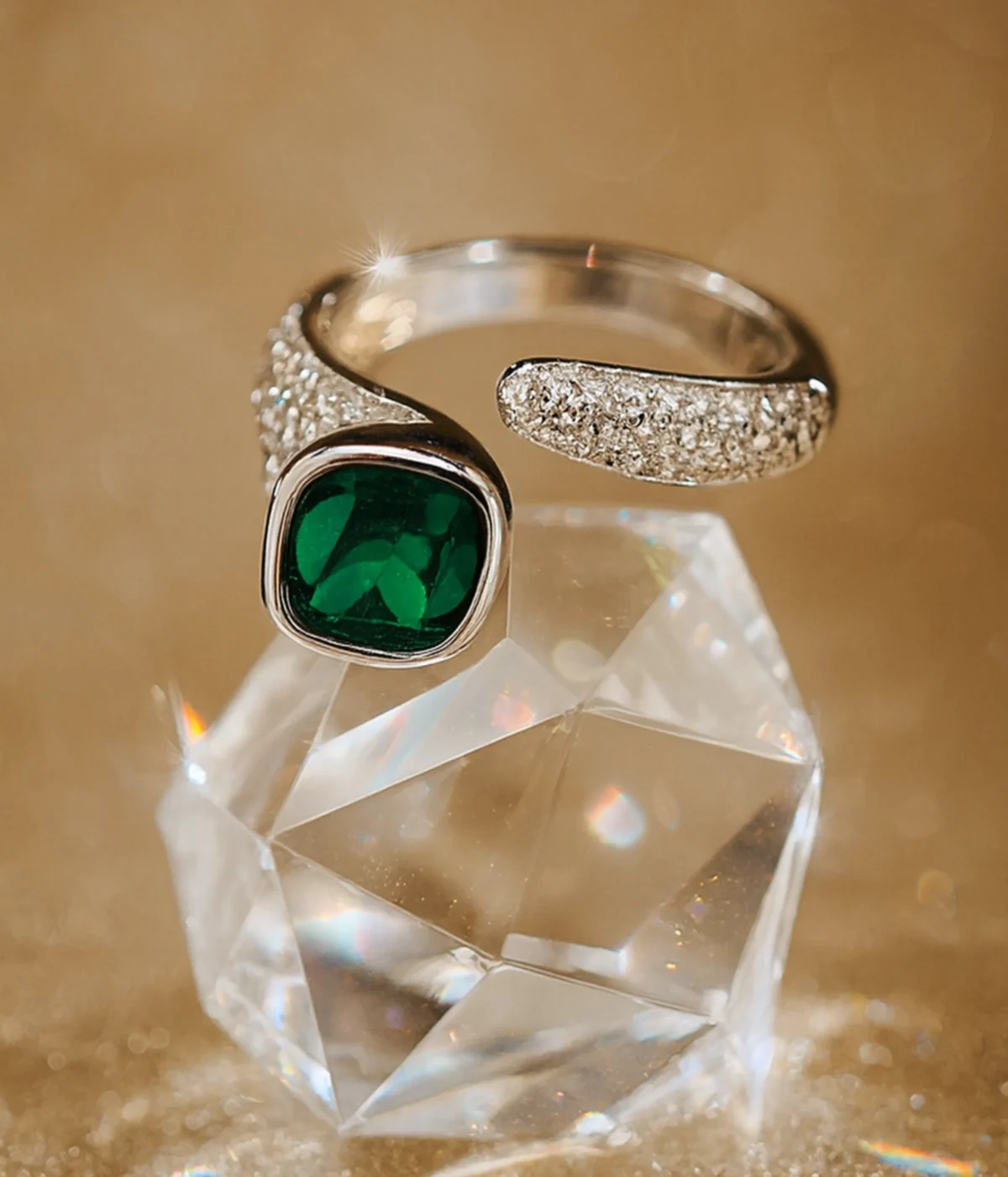 Sterling Silver Green Stone Statement Ring. Features a bold cushion-cut simulated Emerald gem and a dazzling pave CZ open bypass band. Modern Cocktail Ring.