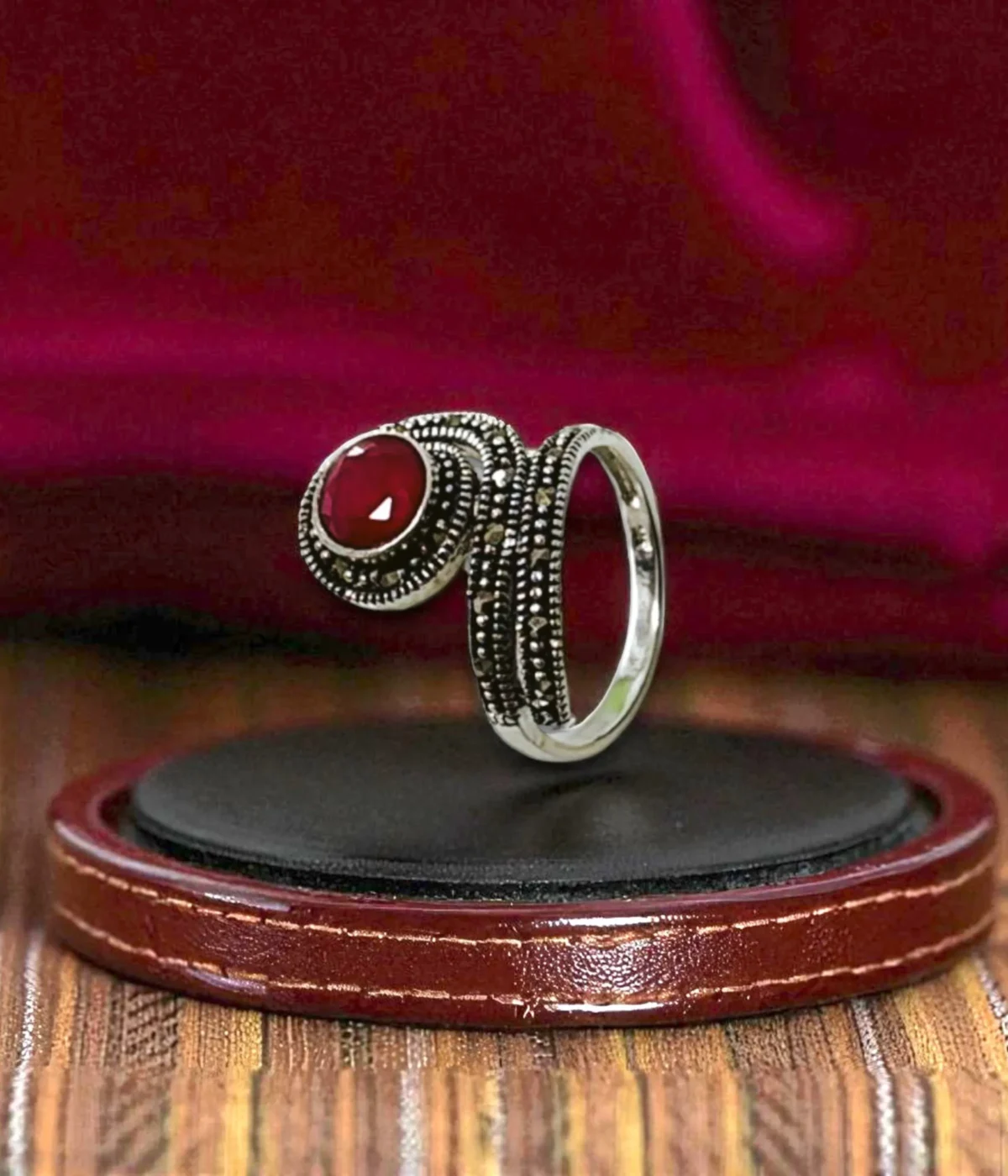 Vintage Marcasite Coil Ring. Oxidized Sterling Silver wrap ring featuring a large faceted Ruby Red center stone and detailed Marcasite accents. Antique Statement Jewelry.