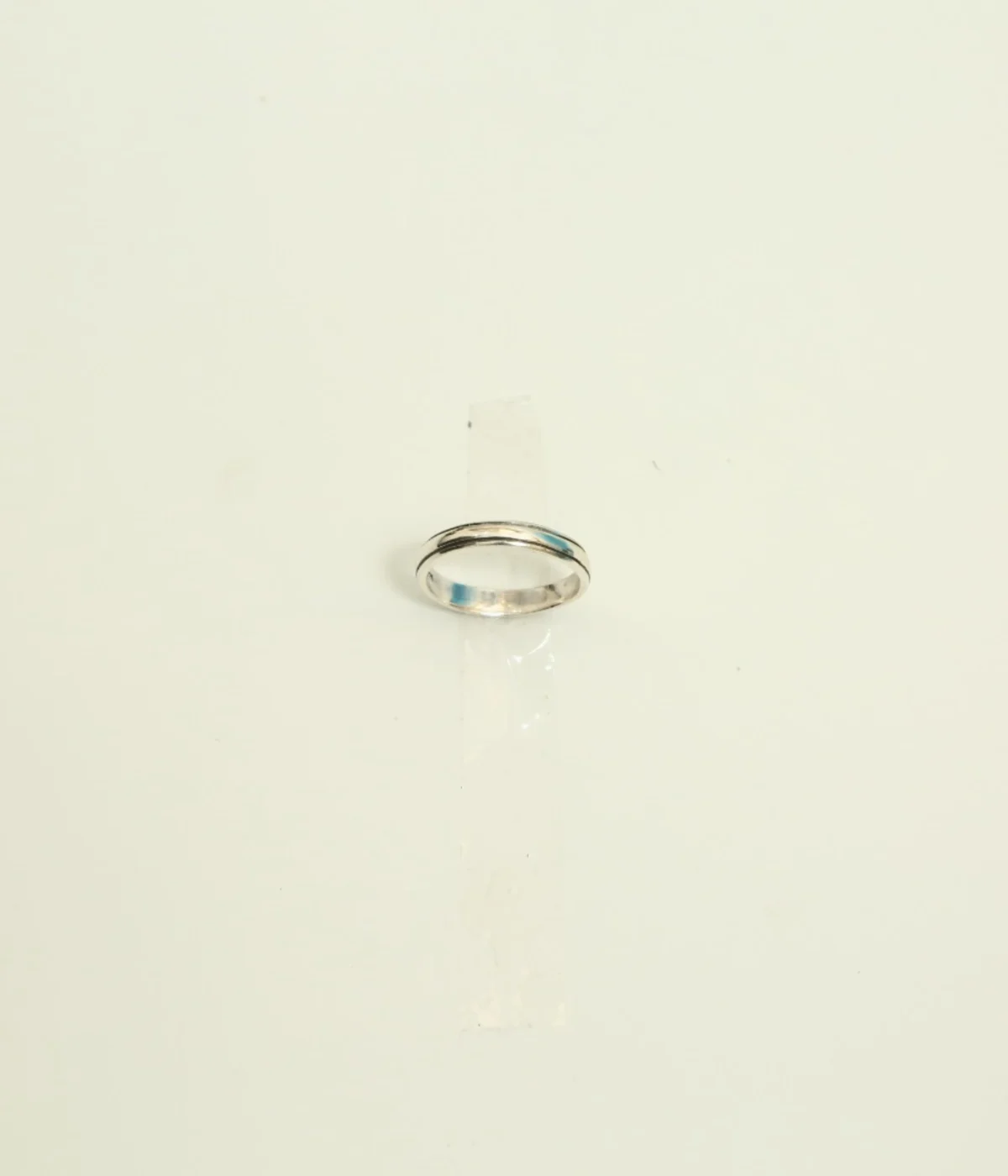 Men's Sterling Silver Minimalist Band Ring featuring a central grooved design. The polished 925 Silver ring is displayed on a white surface, suitable for everyday wear.