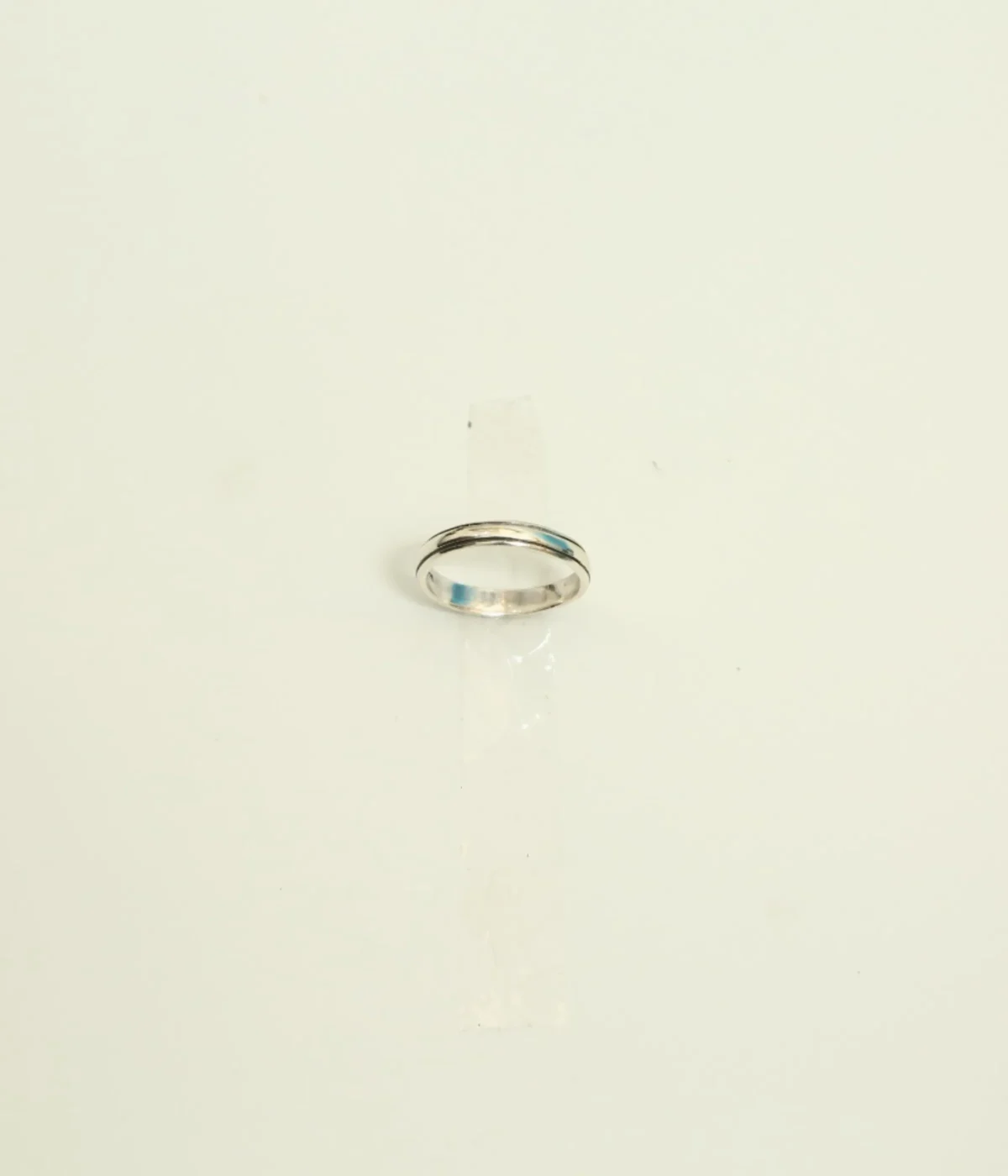 Men's Sterling Silver Minimalist Band Ring featuring a central grooved design. The polished 925 Silver ring is displayed on a white surface, suitable for everyday wear.