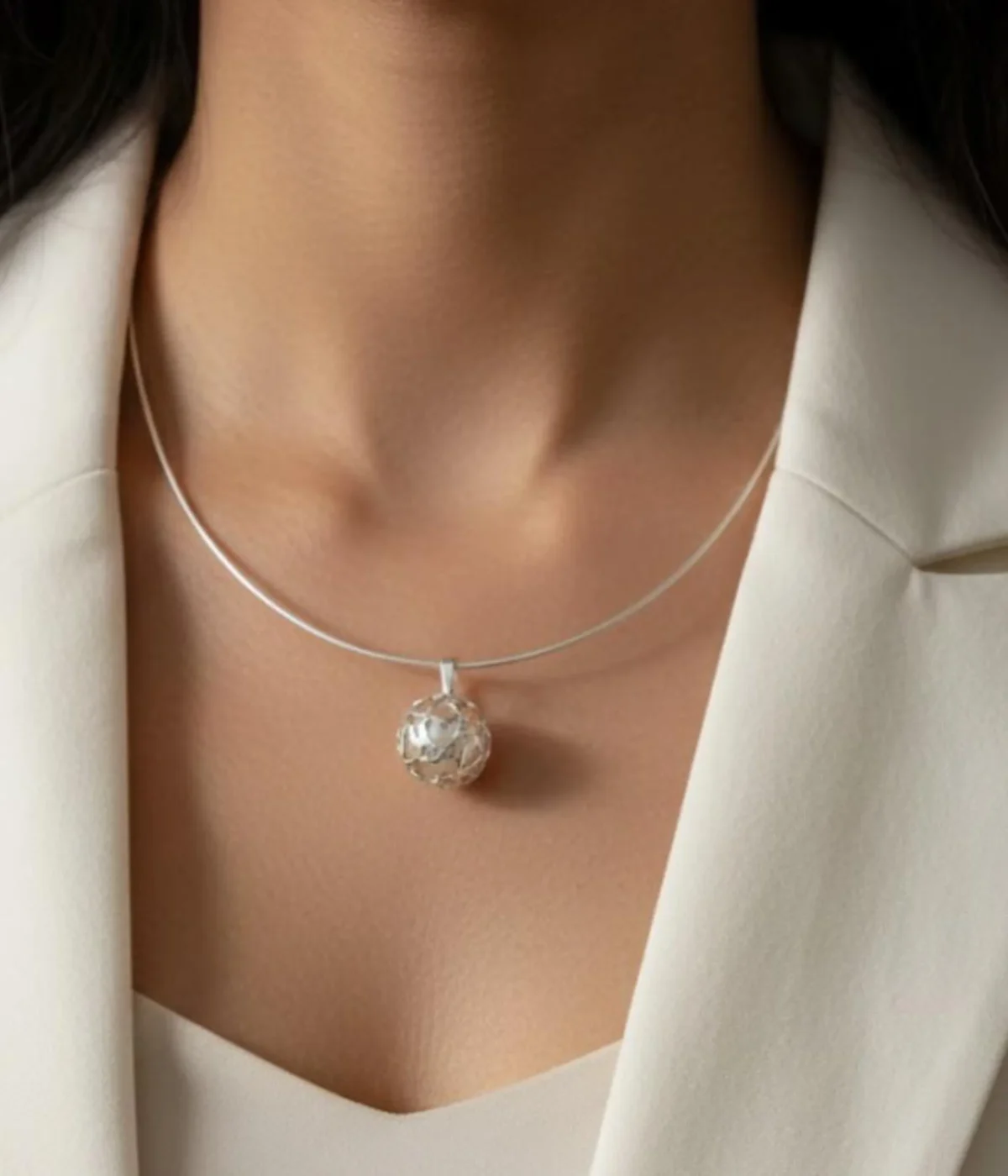 Sterling Silver Filigree Collar Necklace and Drop Earring Set. Features a sleek silver band and unique mesh ball pendant and earrings. Displayed on a carved wooden box.