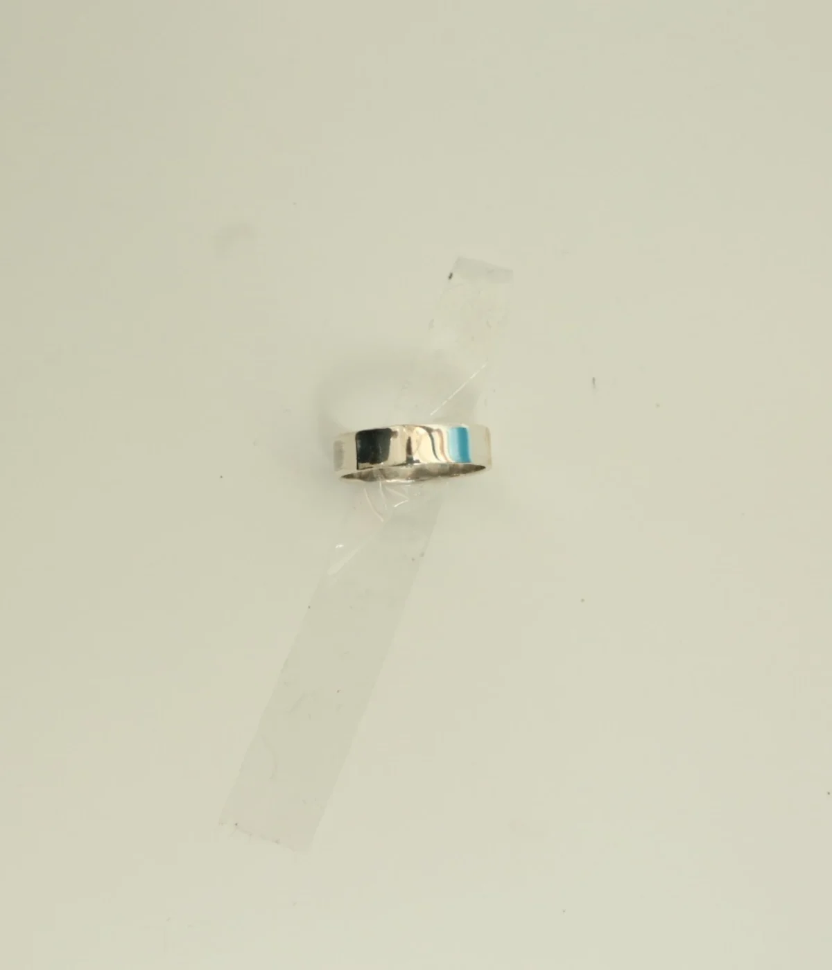 Men's Sterling Silver Minimalist Band Ring featuring a central grooved design. The polished 925 Silver ring is displayed on a white surface, suitable for everyday wear.