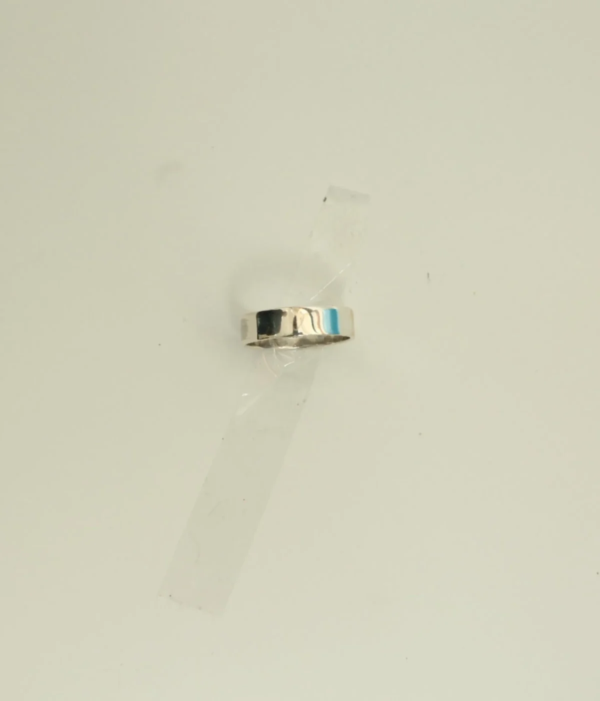 Men's Sterling Silver Minimalist Band Ring featuring a central grooved design. The polished 925 Silver ring is displayed on a white surface, suitable for everyday wear.