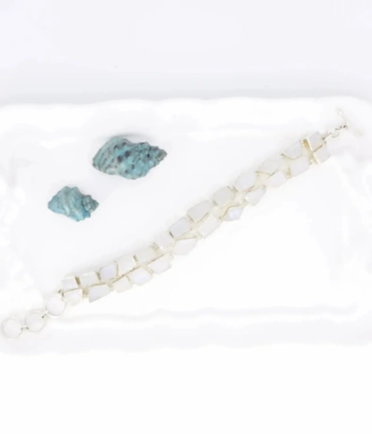 NeerSterling Silver Moonstone link bracelet featuring two rows of unevenly cut stones on a white background.