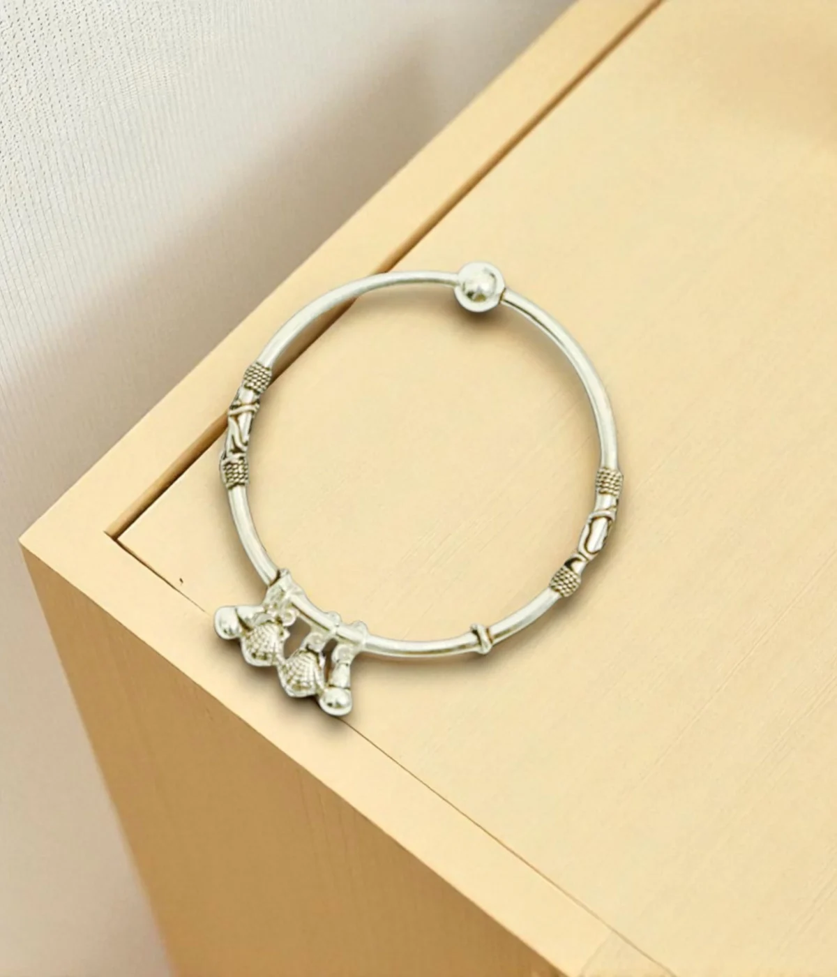 925 Sterling Silver Ghungroo Bangle | Oxidized Tribal Charm Bracelet with jingle bells on a dark blue background.