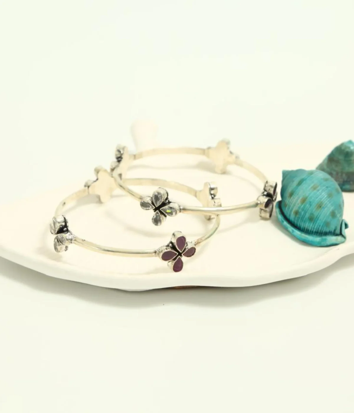 Pair of Sterling Silver Clover Bangle Bracelets. Fixed set with one bangle featuring Ruby/Magenta stones and the second featuring Clear CZ stones. Two-Tone Minimalist Kada Set.