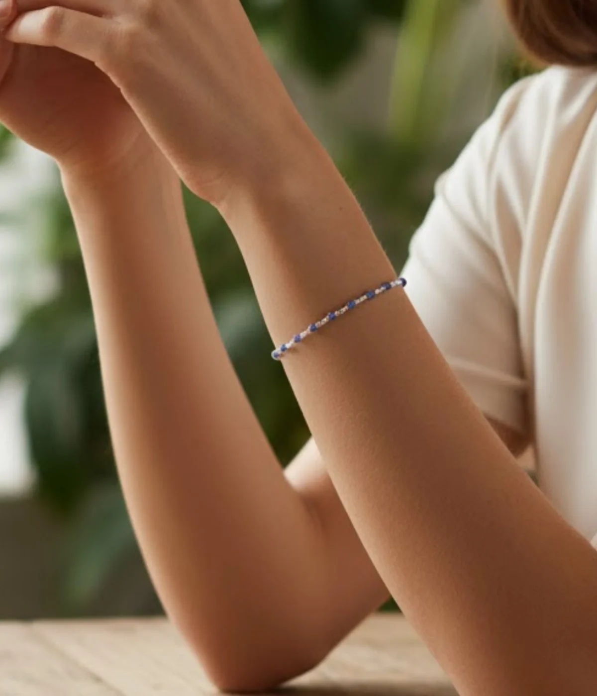 Neersterling Pair of Oxidized Sterling Silver Cuff Bangles worn on a woman's wrist. Ethnic Indian Kada style featuring prominent Ruby (red) and Emerald (green) gemstone accents on an antique finish.