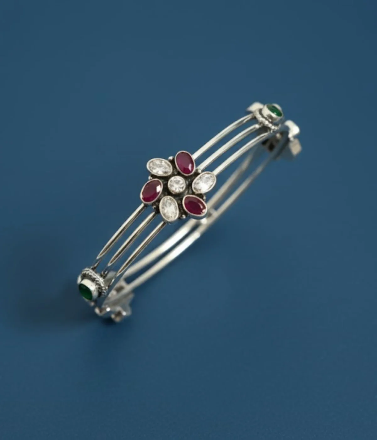 Sterling Silver Multi-Strand Bangle. Features a central Floral motif set with Ruby (maroon) and clear CZ gemstones. Stackable bracelet with a layered design, ideal for daily wear Indian jewelry.