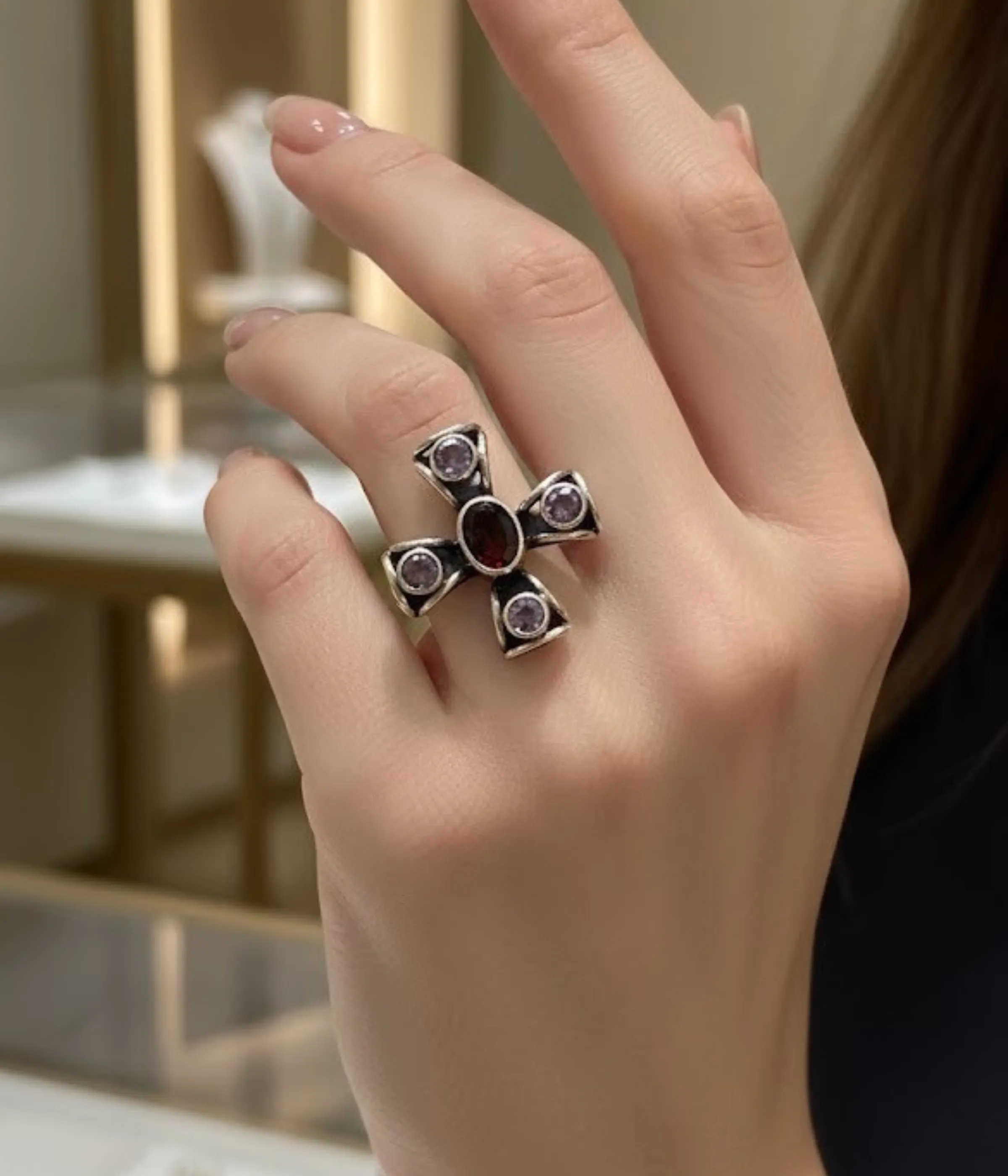 Sterling Silver Cross Statement Ring. Antique-style design featuring a central Garnet-style red oval gem and four surrounding Amethyst-style purple stones. Religious and Gothic jewelry.