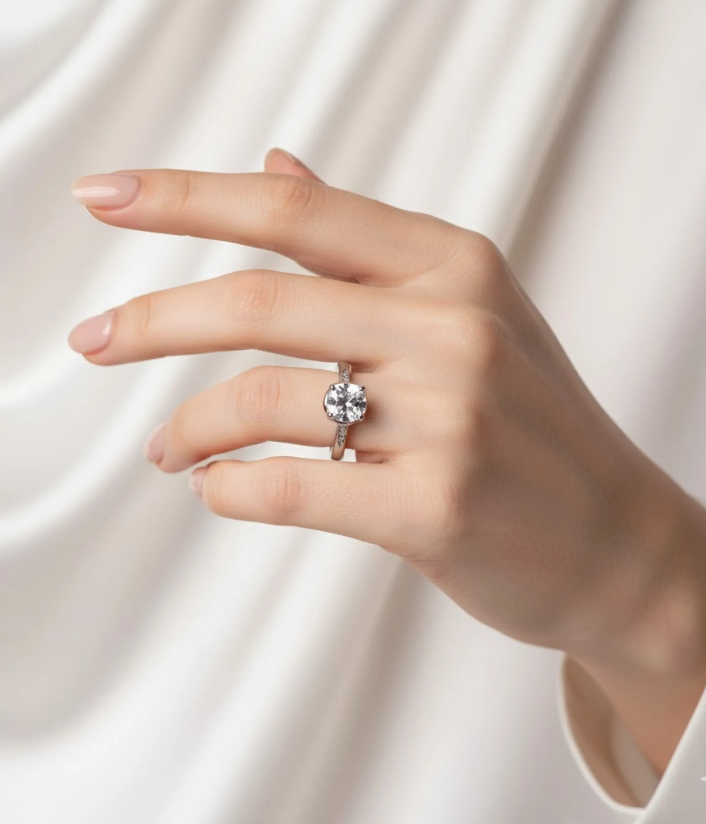 Sterling Silver Solitaire Ring. Classic design with a brilliant Round CZ center stone and Pave accent stones on the band. Ideal Engagement or Promise Ring.