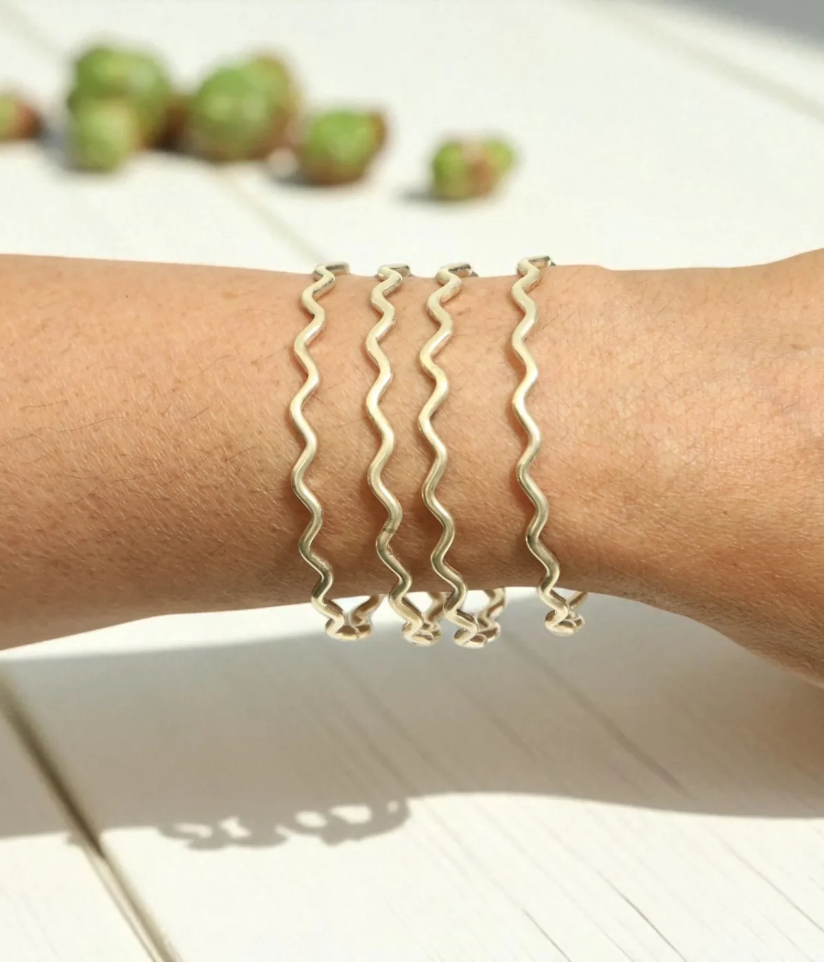 Set of 4 Sterling Silver Wave Stacking Bangles featuring a minimalist ripple texture. Dainty 925 silver layering jewelry and a unique everyday gift for women.