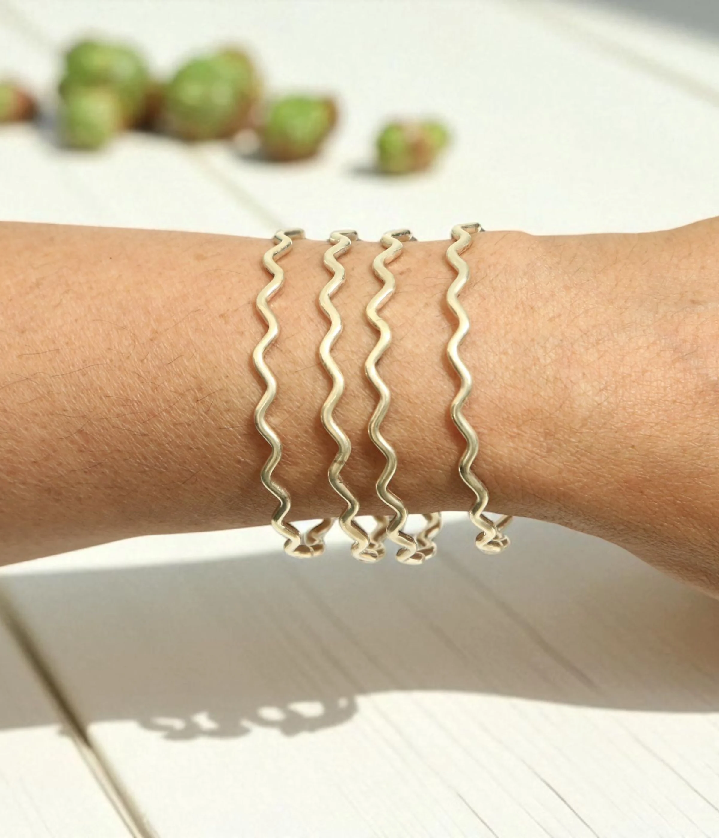Set of 4 Sterling Silver Wave Stacking Bangles featuring a minimalist ripple texture. Dainty 925 silver layering jewelry and a unique everyday gift for women.