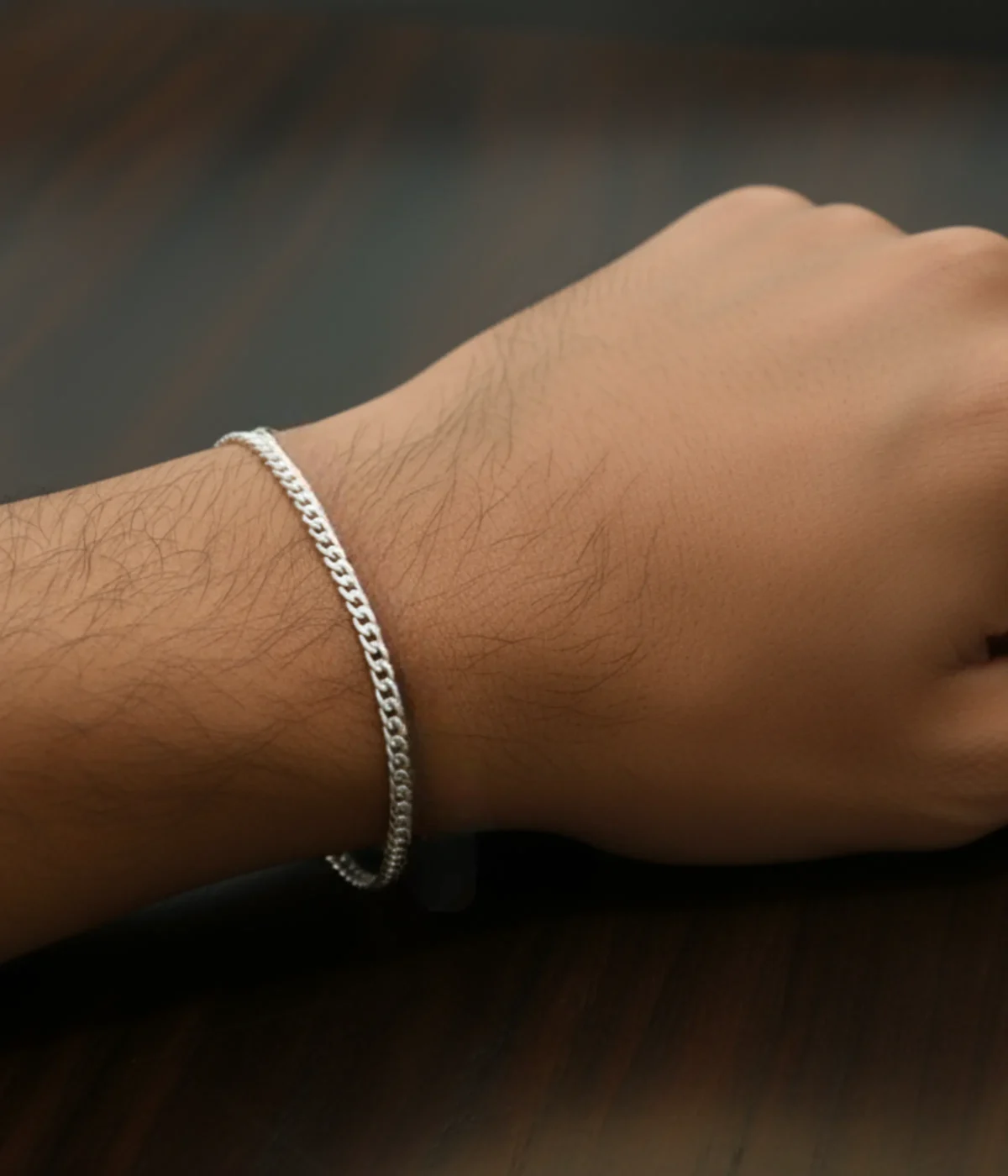 Men's Sterling Silver Curb Chain Bracelet (Cuban link style) displayed on a dark surface next to polished Tiger's Eye stones. A classic 925 Silver Link Kada.