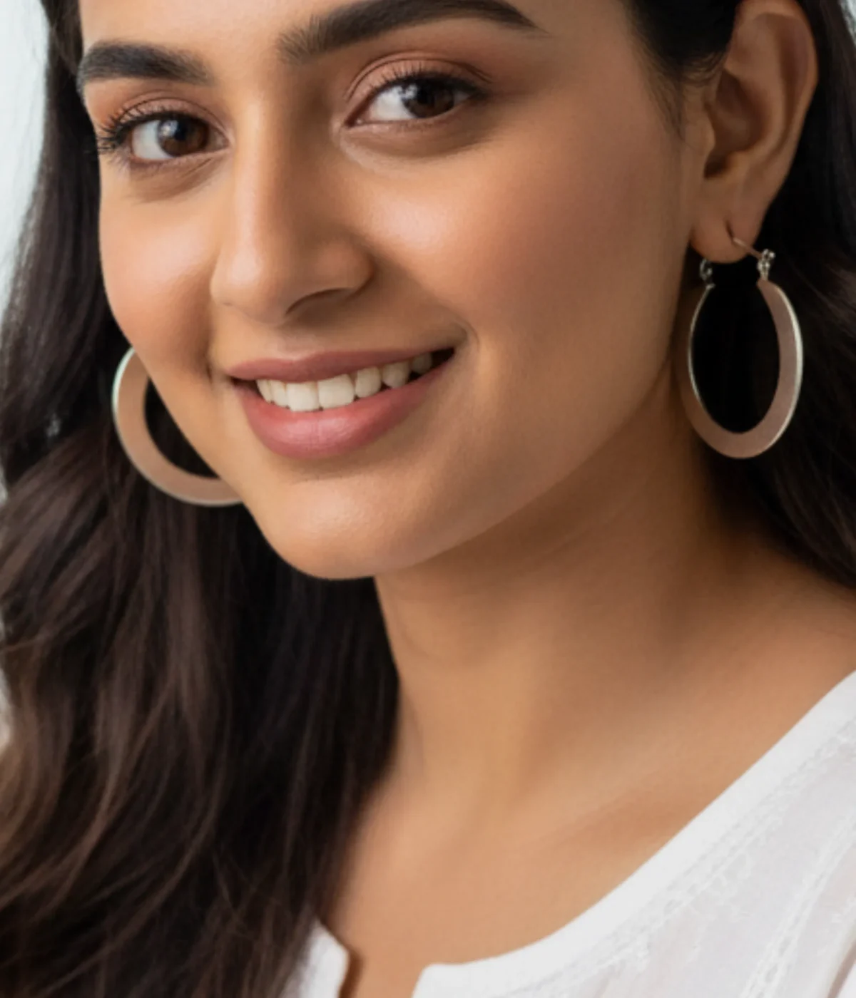 Pair of Chunky Silver Square Hoop Earrings. Thick, geometric hoops with a high polish finish, displayed on a white jewelry stand in a minimalist setting.