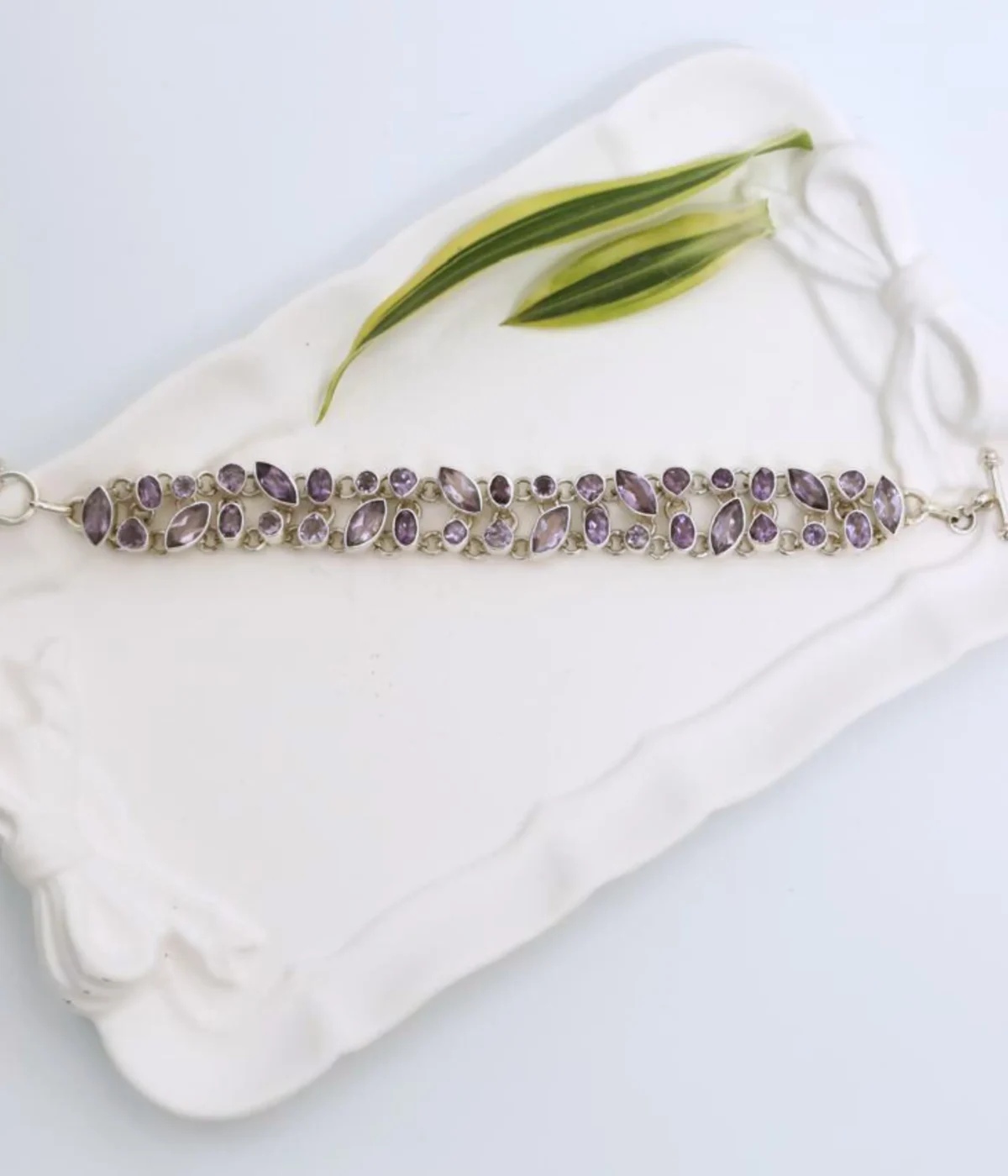 NeerSterling Silver Amethyst Link Bracelet featuring a double row cluster of marquise and round purple gemstones. Elegant 925 silver statement jewelry for women.