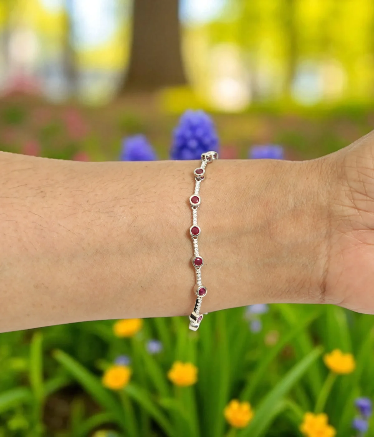 Sterling Silver Pink Gemstone Line Bracelet with round solitaire stations. Dainty 925 silver chain featuring evenly spaced pink/ruby-colored stones. Minimalist stacking bracelet.