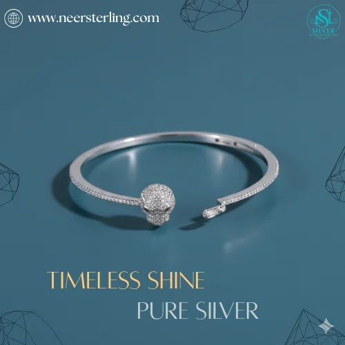 Neersterling Silver-tone open cuff bangle with a pave CZ circle centerpiece and rhinestone-lined edges.