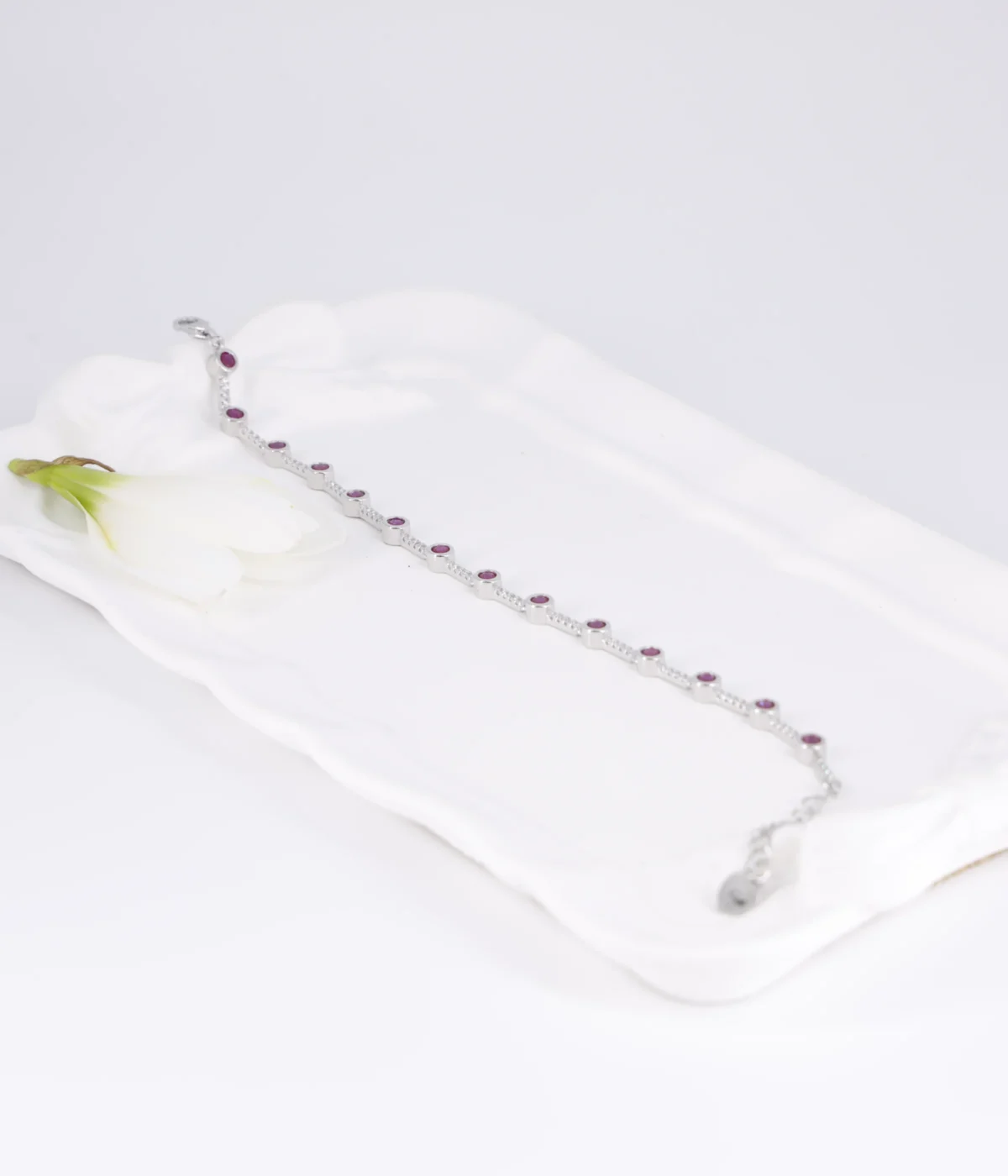 Sterling Silver Pink Gemstone Line Bracelet with round solitaire stations. Dainty 925 silver chain featuring evenly spaced pink/ruby-colored stones. Minimalist stacking bracelet.