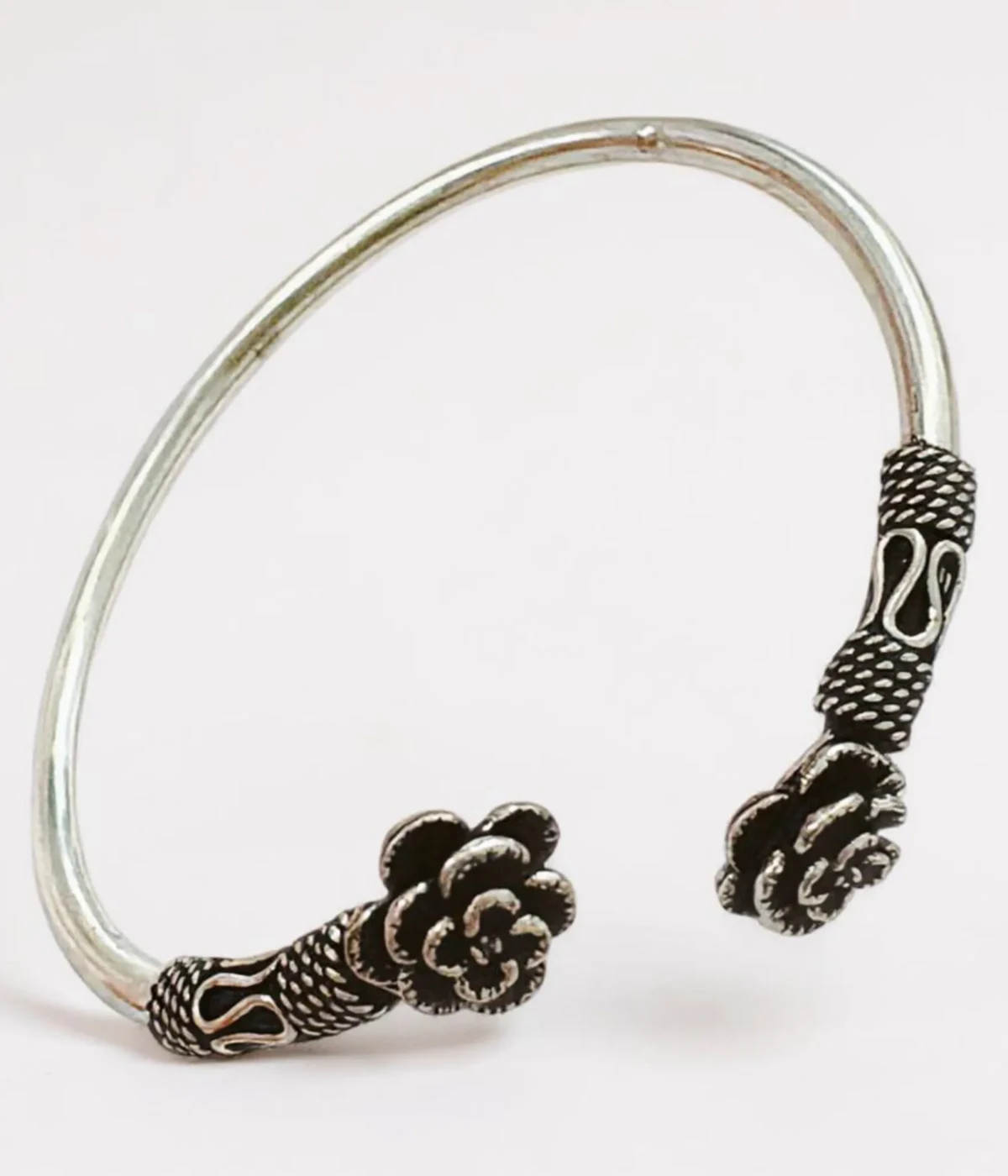 Neersterling Oxidized silver open cuff bangle with detailed floral rose ends.