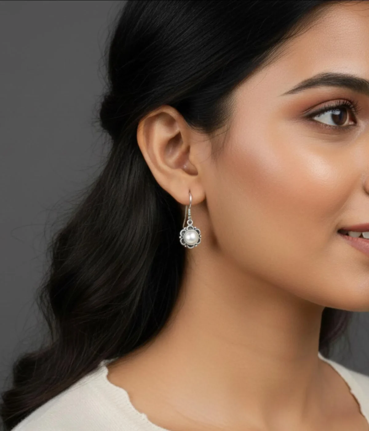 Pair of Dainty Flower Pearl Drop Earrings (2.3 gm). Features a white pearl set in a silver floral frame on secure hooks, displayed on a red velvet stand inside a dark wood gift box.