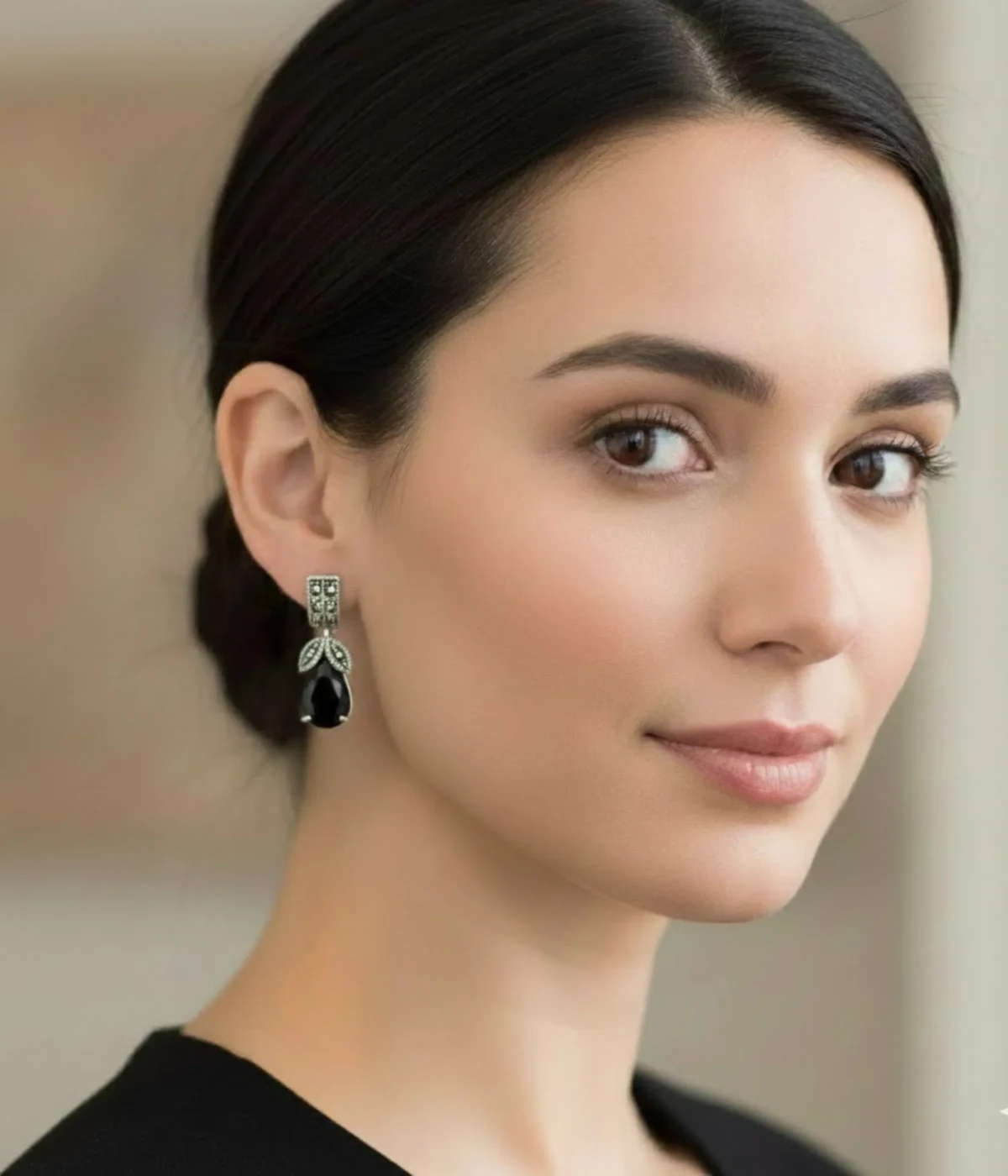 Oxidized Silver Black Onyx Drop Earrings (6.3 gm) with ornate vintage detailing and a teardrop black stone. The earrings are shown resting on a blue velvet pillow inside a wooden jewelry box on a vanity table.