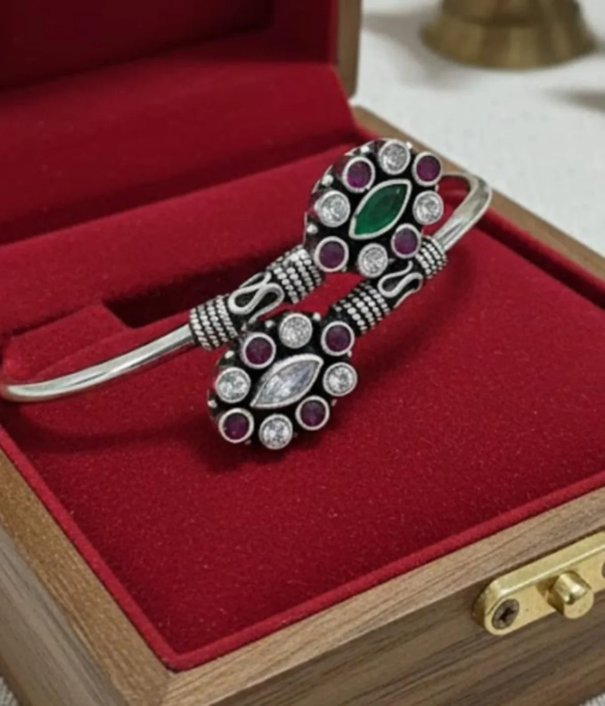 Premium 16.3 gm oxidized silver floral stone bracelet featuring a vibrant emerald green and ruby-maroon dual-flower design on a white background.