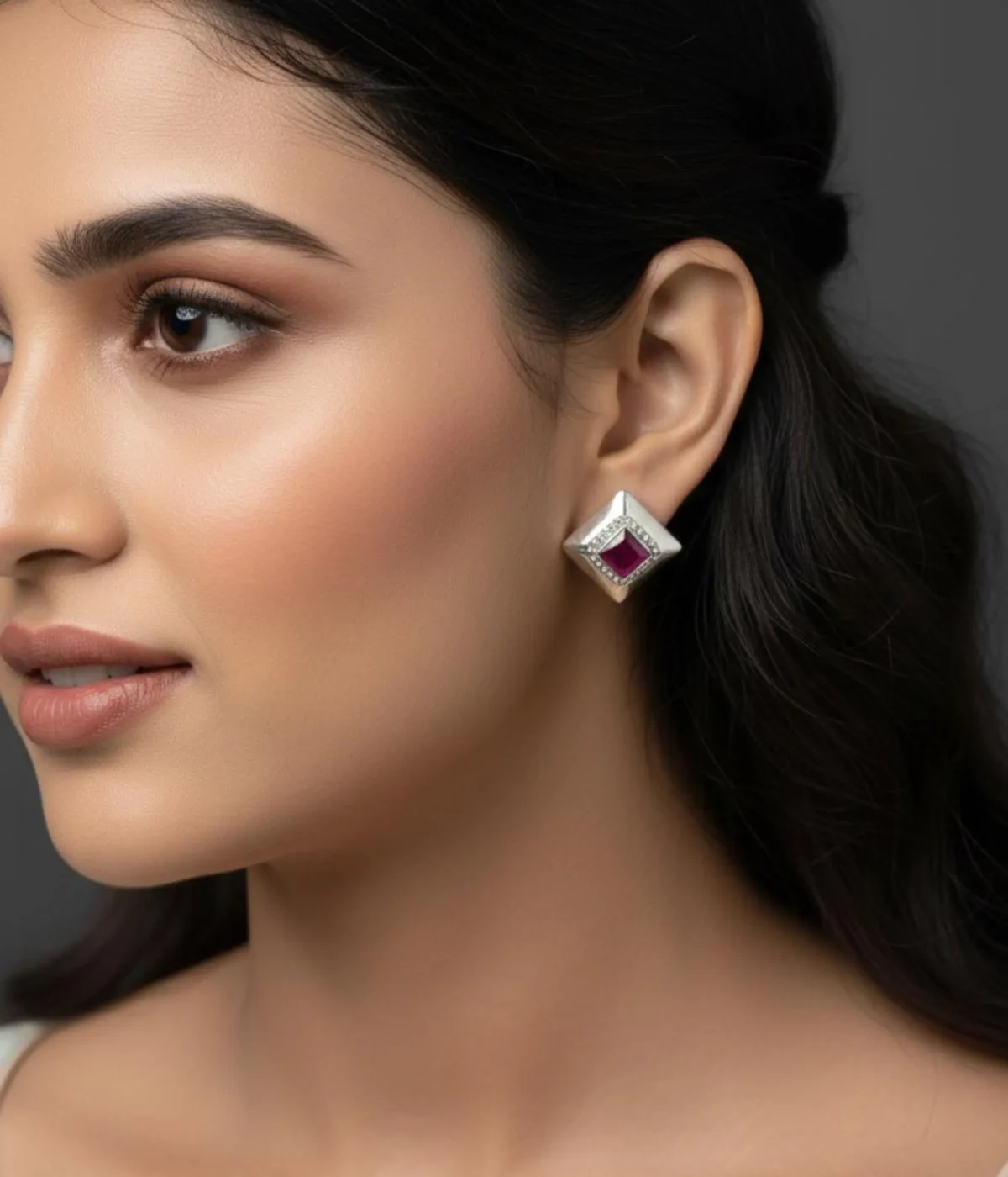 Pair of Oxidized Square Stud Earrings (5.7 gm). Vintage geometric style jewelry with a central Ruby CZ Stone and small clear accents, displayed in an open dark wood box with red velvet lining.