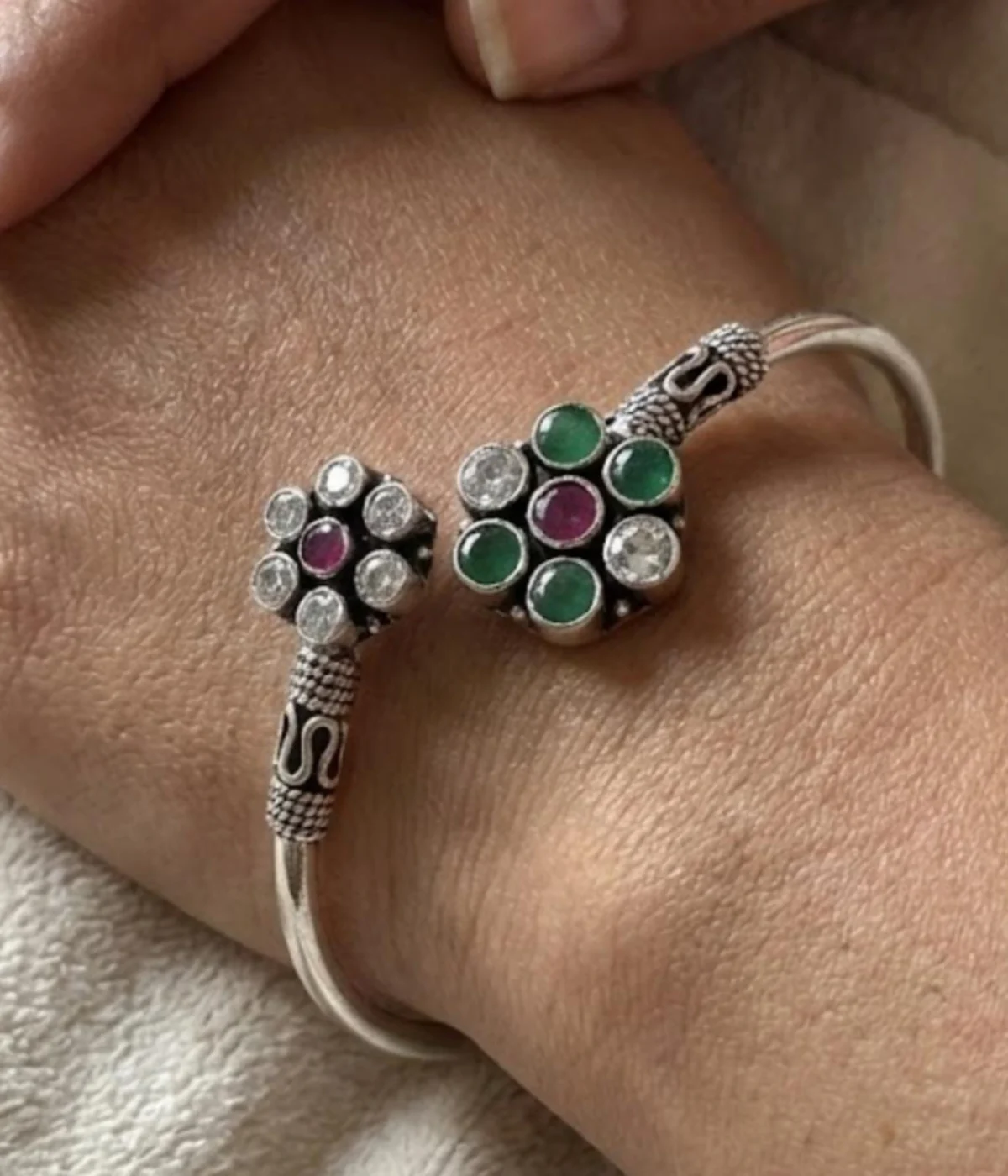 Handcrafted 15.4 gm oxidized silver floral stone bracelet featuring emerald green and ruby maroon accents worn as a traditional Indian Kada.