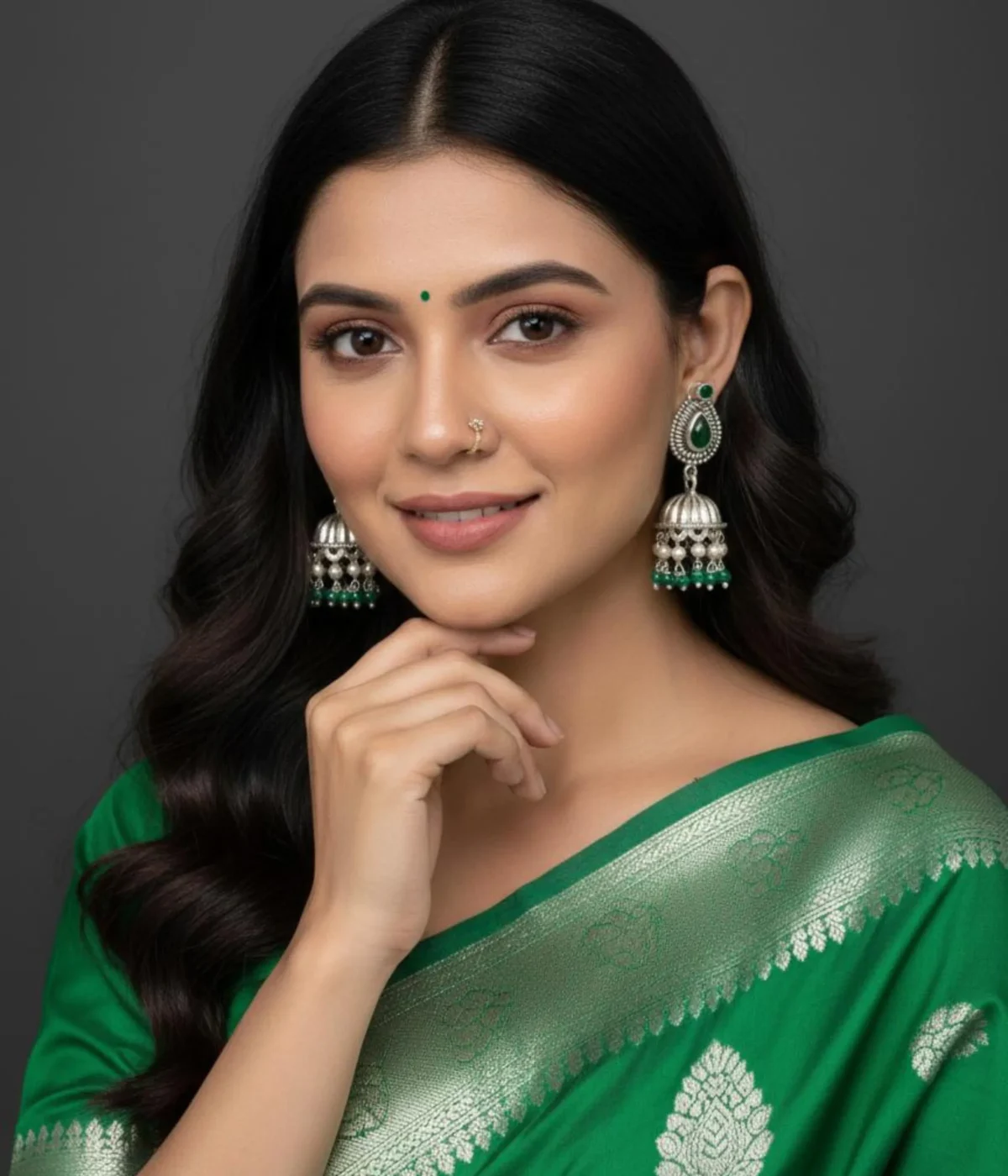 Traditional Oxidized Jhumka Earrings (12.5 gm) being worn. Features a Green Stone Stud, bell shape, and dangles made of small pearls and green beads. Indian Festive Ethnic Jewelry.
