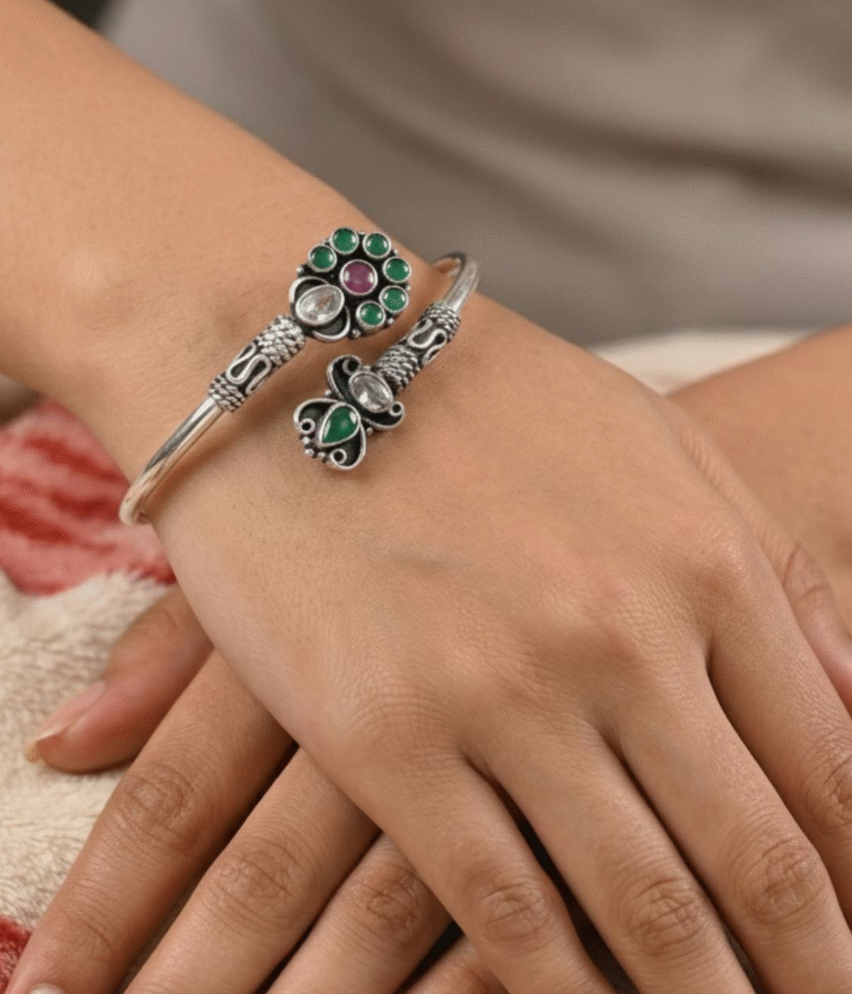 Handcrafted oxidized silver floral bracelet weighing 16.3 grams with green and maroon stone accents in a traditional Indian Kada style