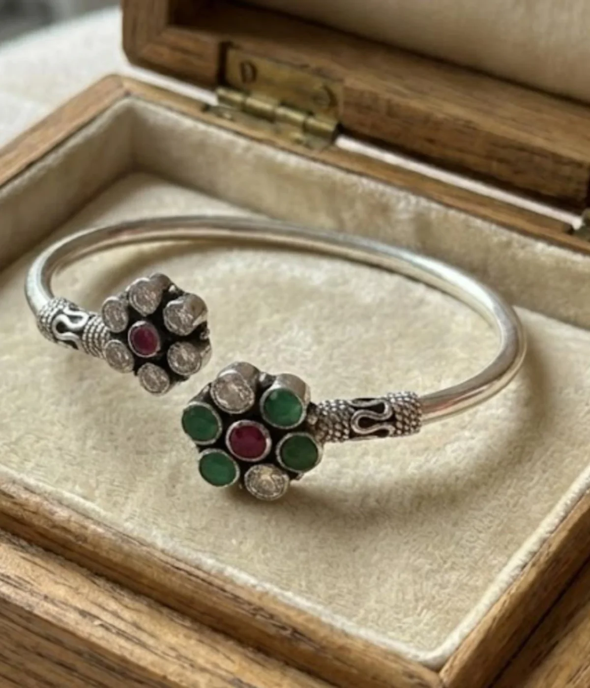 Handcrafted 15.4 gm oxidized silver floral stone bracelet featuring emerald green and ruby maroon accents worn as a traditional Indian Kada.