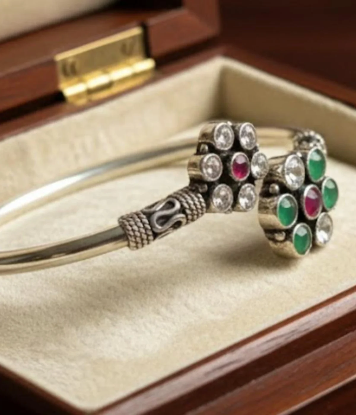 Handcrafted 15.4 gm oxidized silver floral stone bracelet featuring emerald green and ruby maroon accents worn as a traditional Indian Kada.