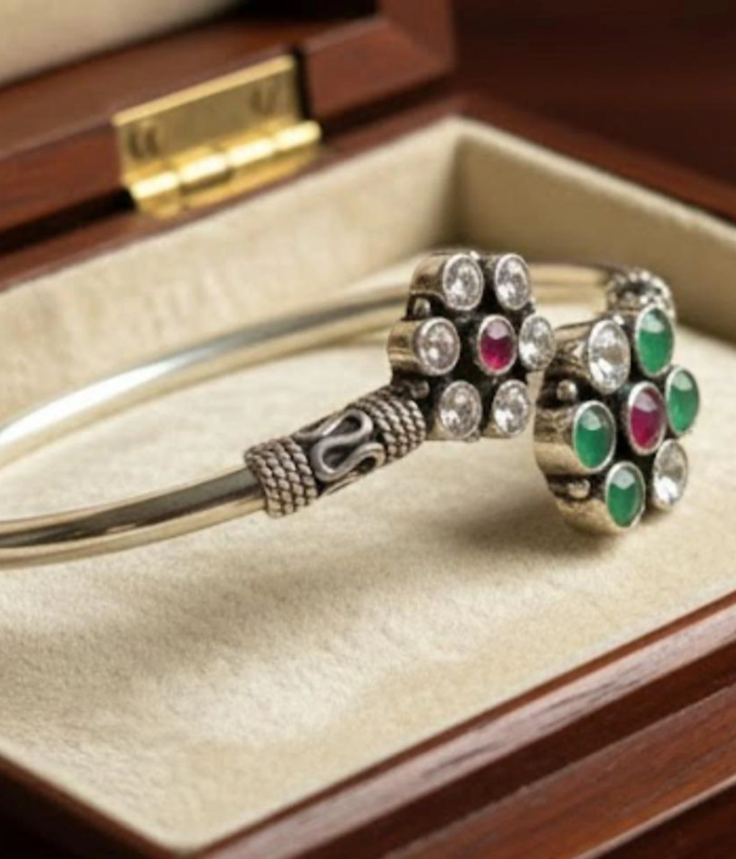 Handcrafted 15.4 gm oxidized silver floral stone bracelet featuring emerald green and ruby maroon accents worn as a traditional Indian Kada.