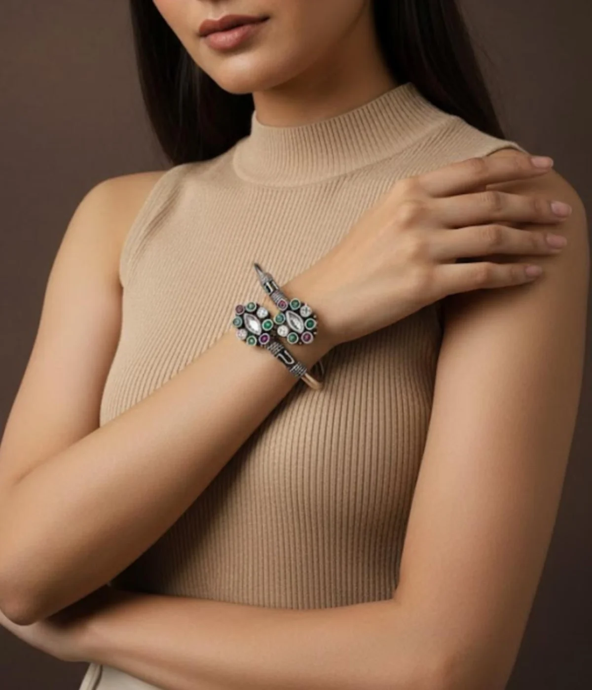 Detailed 16.3 gm oxidized silver floral kada featuring emerald green and maroon stones with clear zirconia accents on a wooden texture.