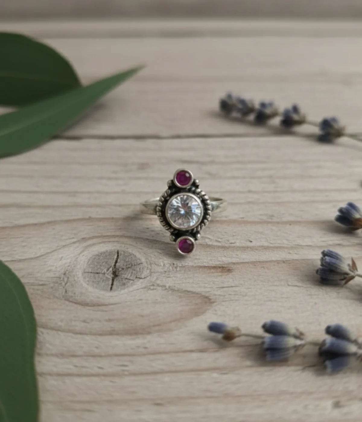 Pair of 6.3g handcrafted sterling silver toe rings with adjustable floral design on a traditional background.