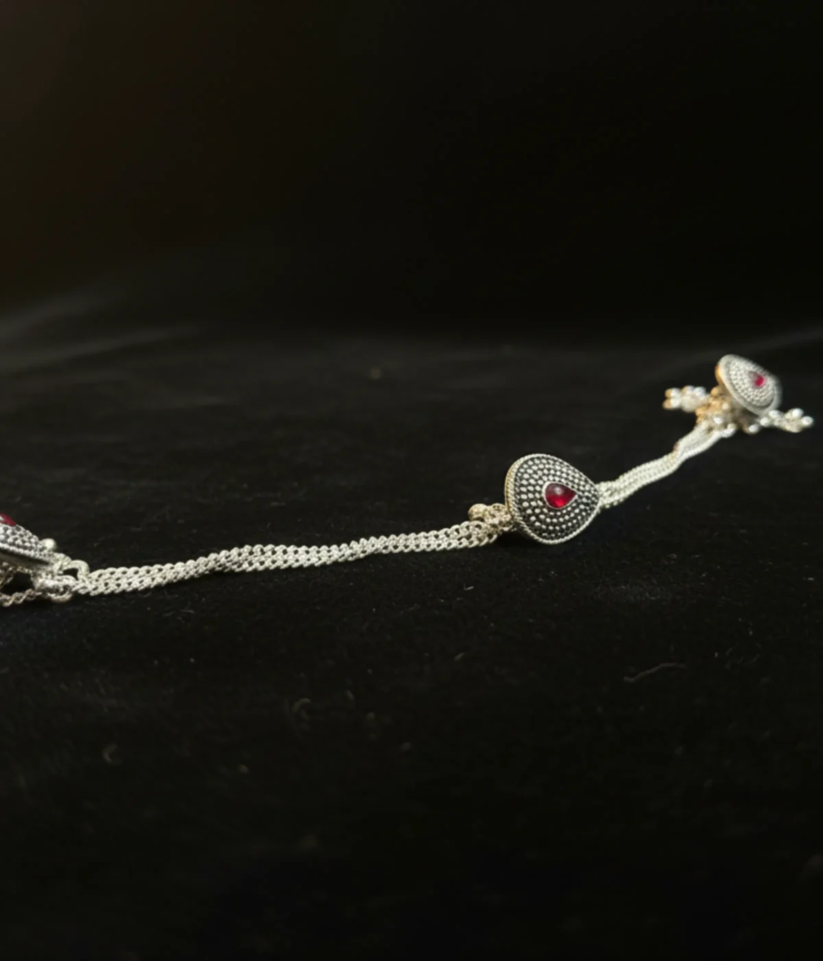 Set of four 30.4g teardrop-shaped antique silver kurta buttons with red stones and dangling beads.
