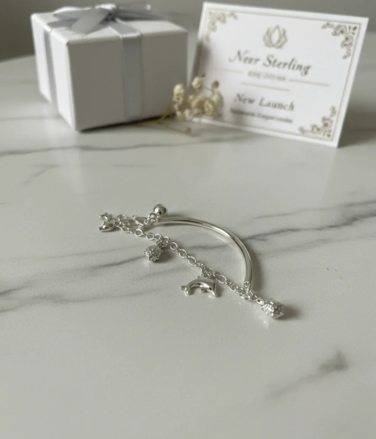 Handcrafted 925 sterling silver kids bracelet with dolphin charms on a child’s wrist, 6g lightweight adjustable bangle.