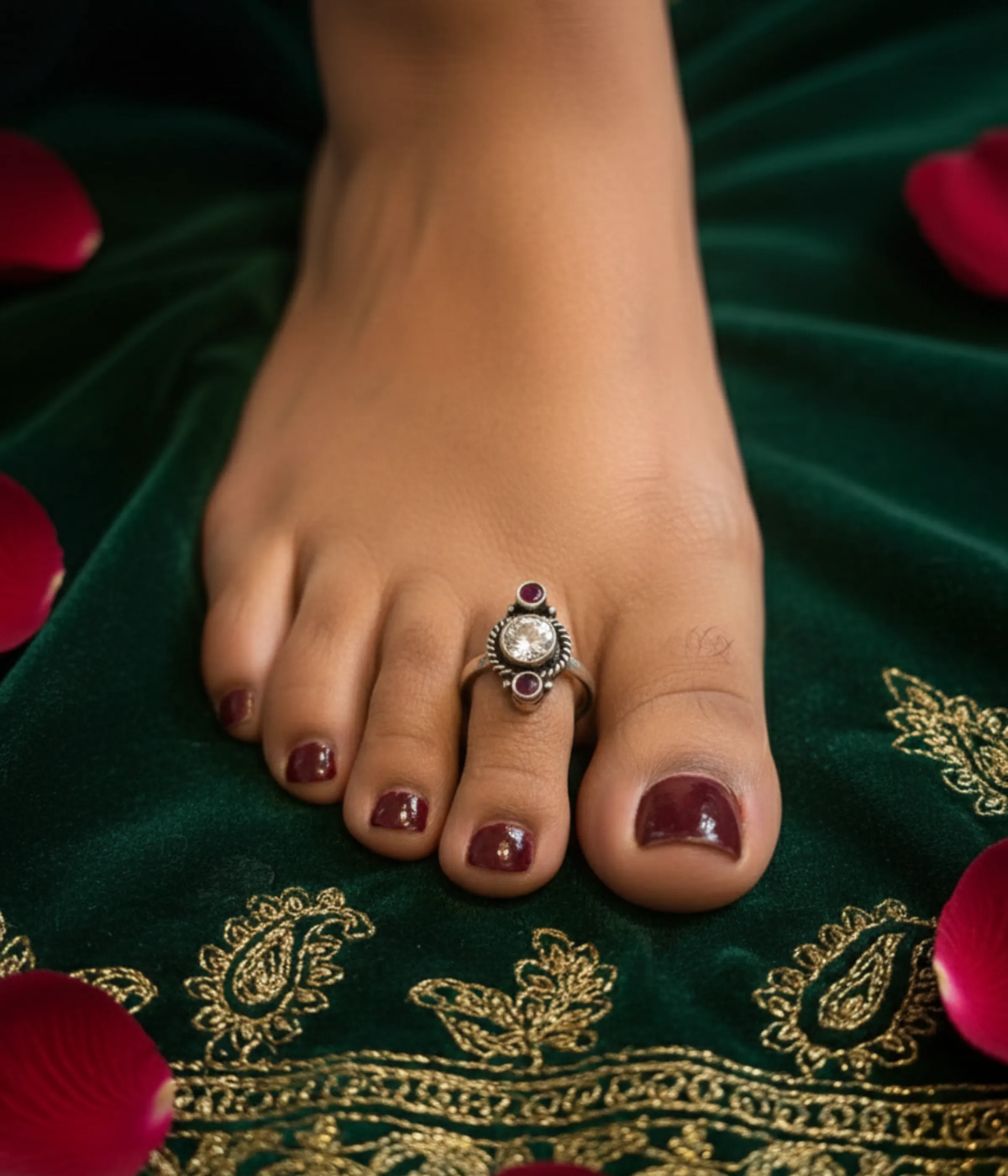Pair of 6.3g handcrafted sterling silver toe rings with adjustable floral design on a traditional background.