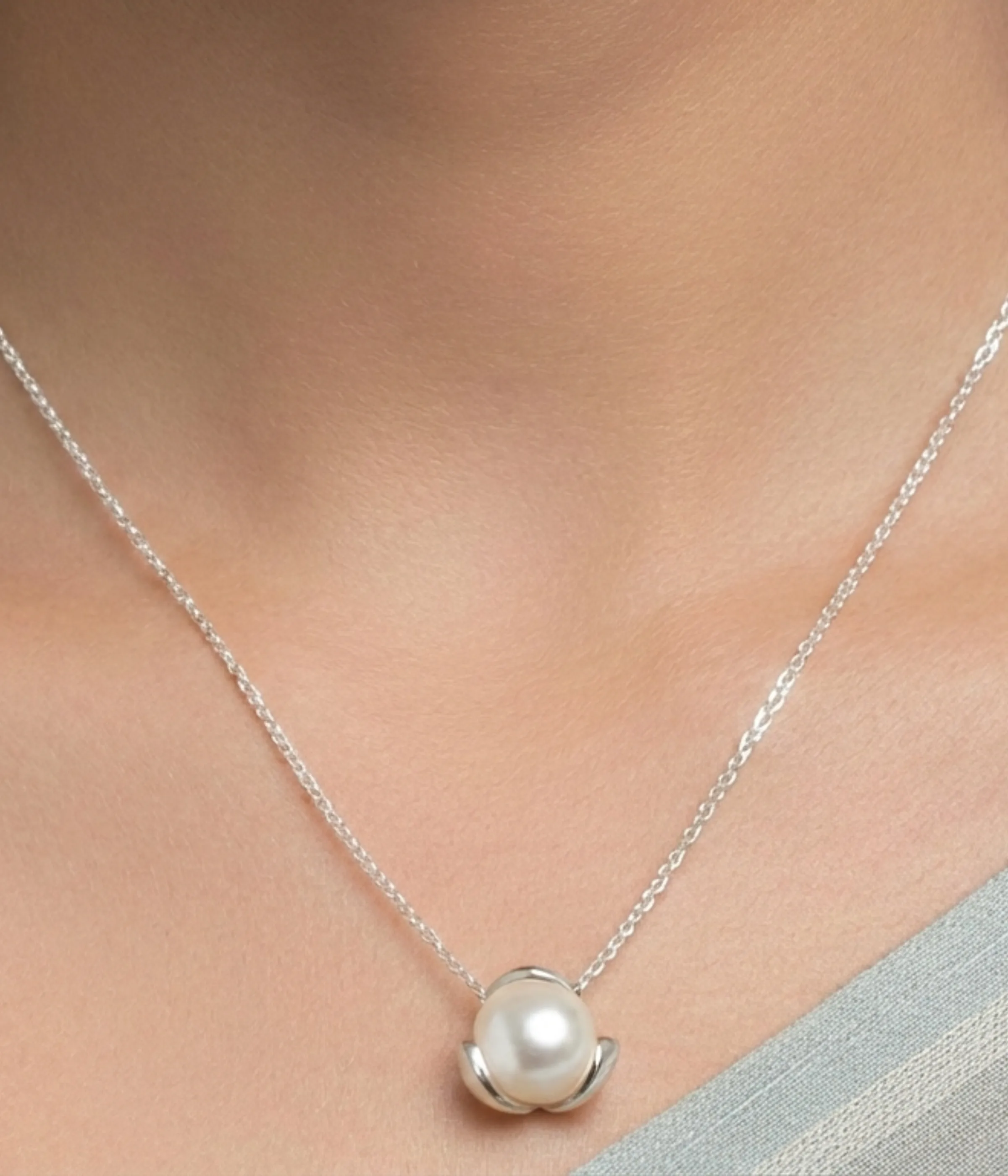 Silver plated necklace with freshwater pearl pendant in minimalist floral setting on chain