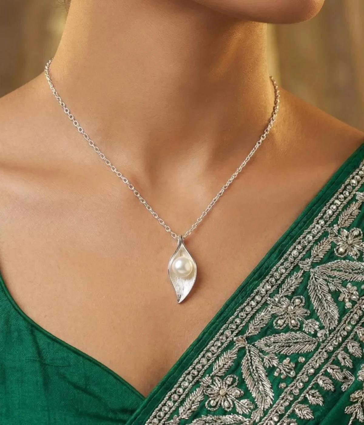 Silver plated necklace with pearl in leaf shaped pendant on delicate chain