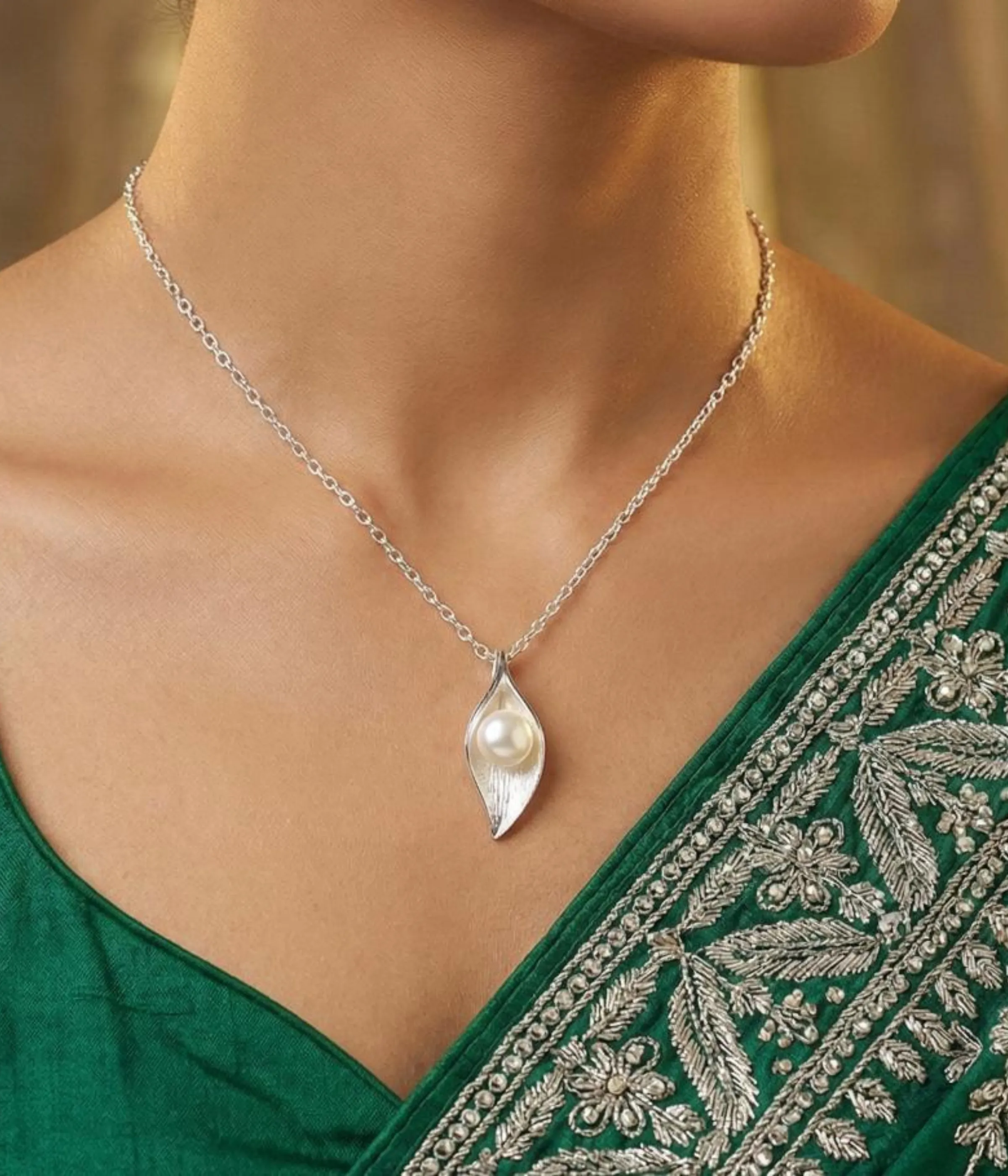 Silver plated necklace with pearl in leaf shaped pendant on delicate chain
